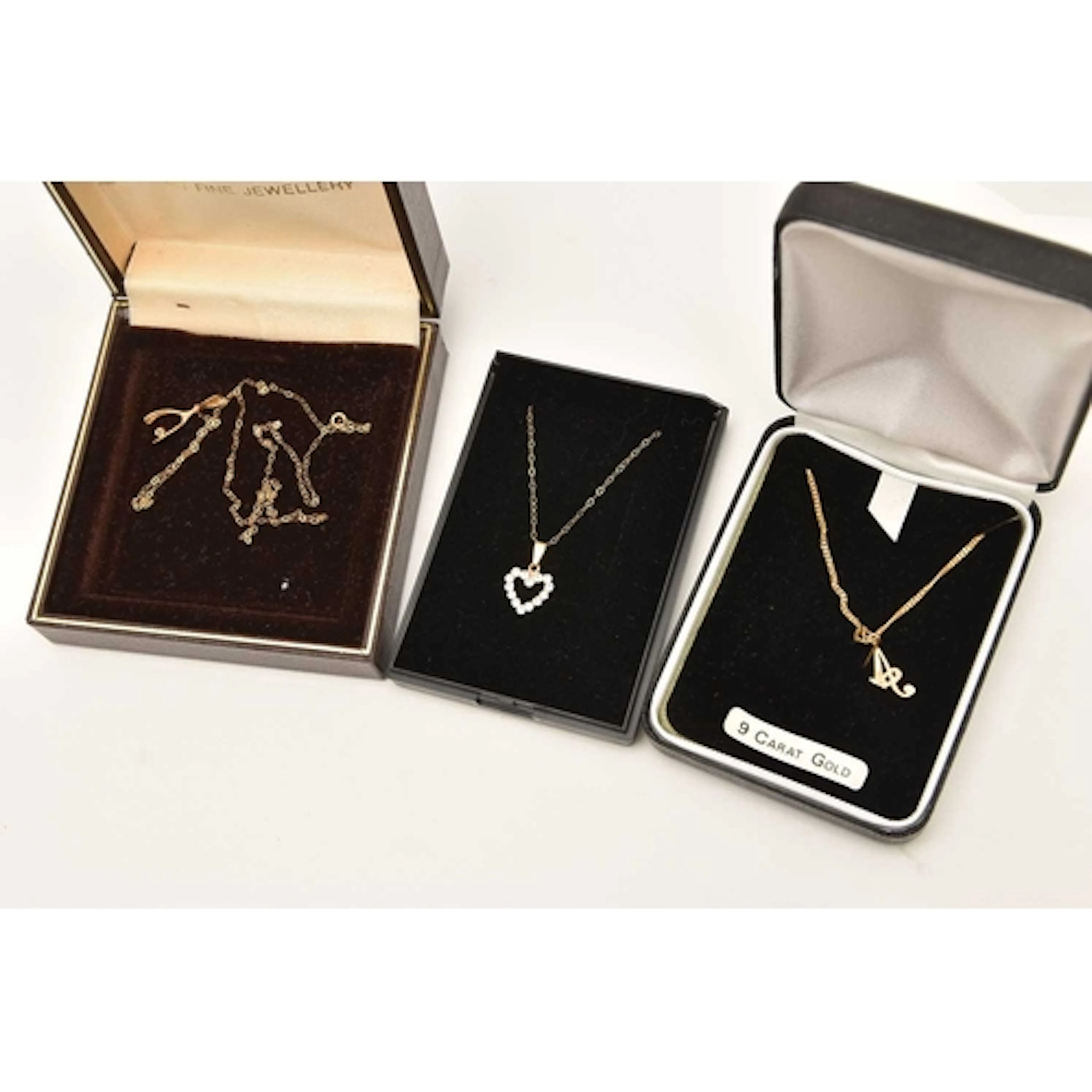 THREE BOXED PENDANT NECKLACES, to include an initial 'A' pen...