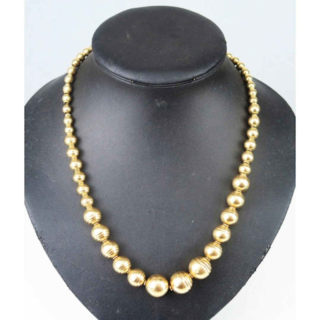 An Italian 14K gold graduated bead necklace interspersed wit...