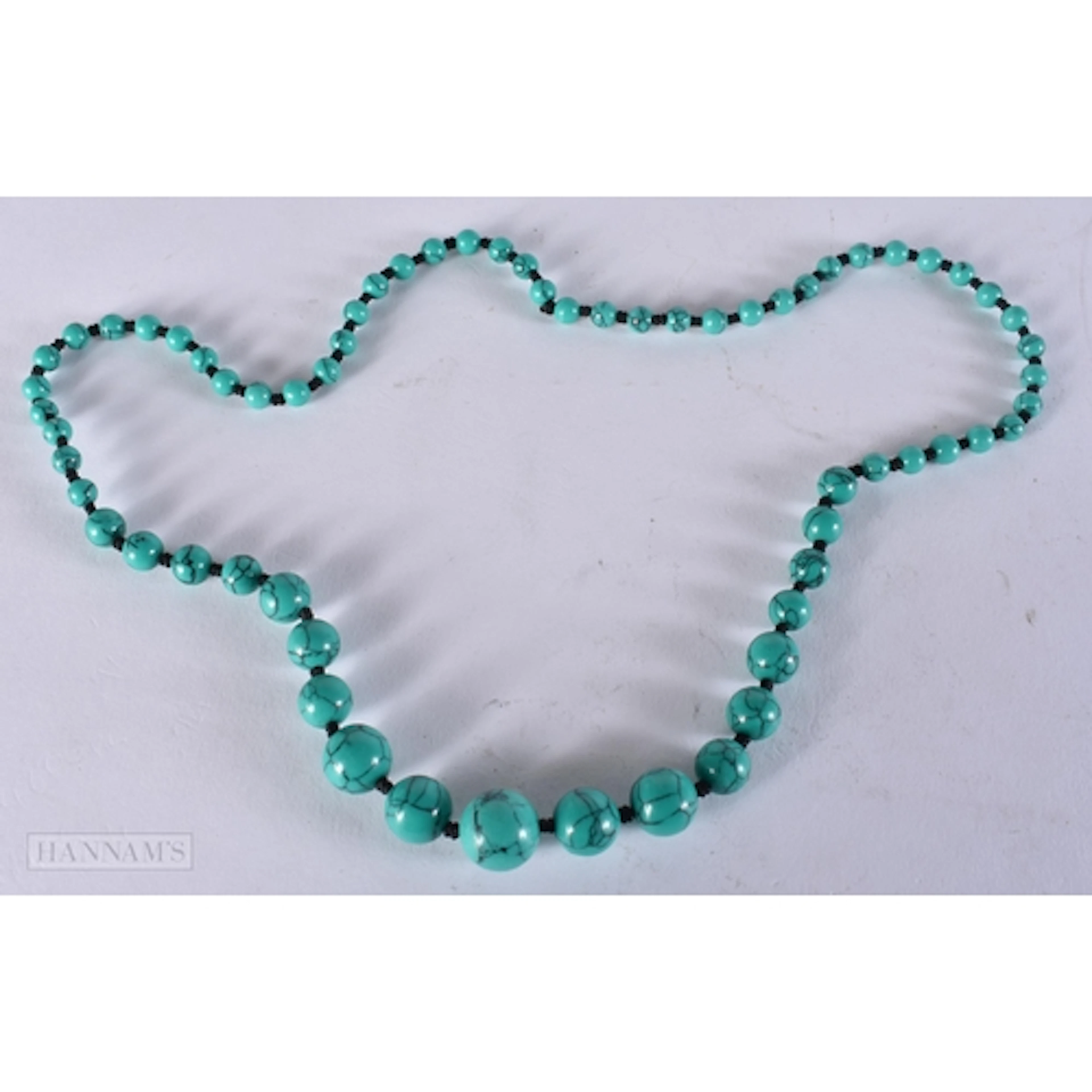 A TURQUOISE STRING BEAD NECKLACE. 62 cm