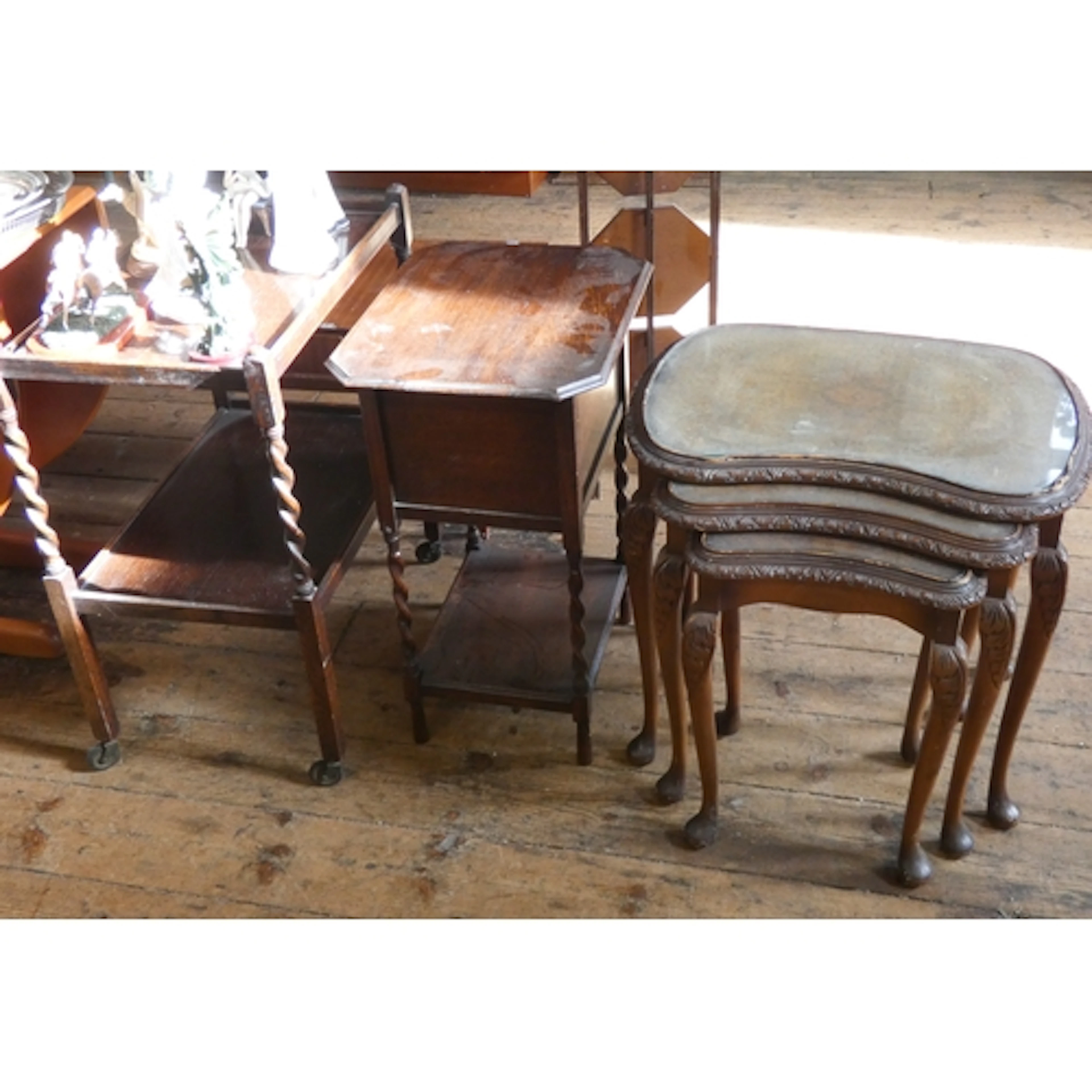 A nest of three walnut coffee tables together with a two-tie...