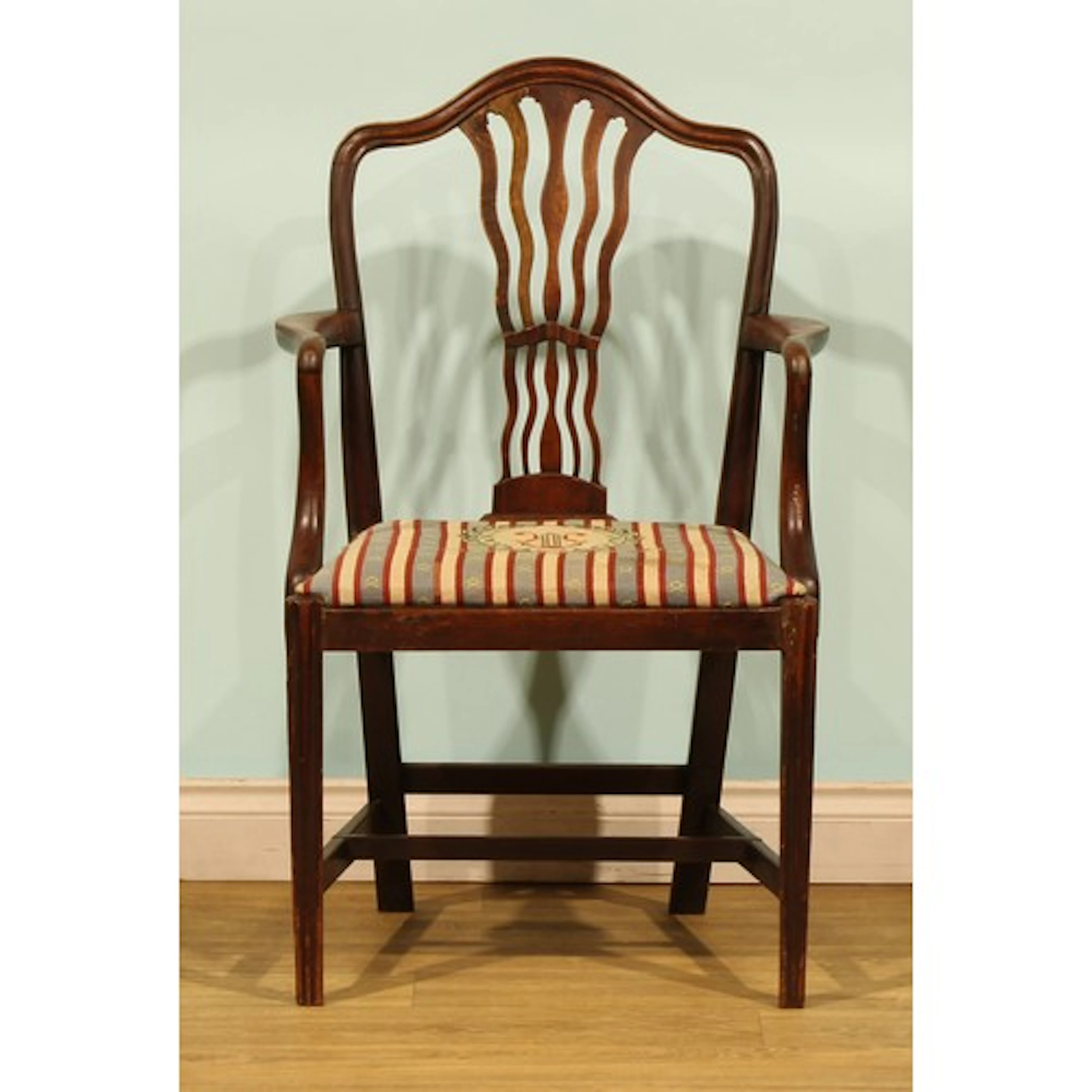 A George III mahogany desk or elbow chair, pierced wavy spla...