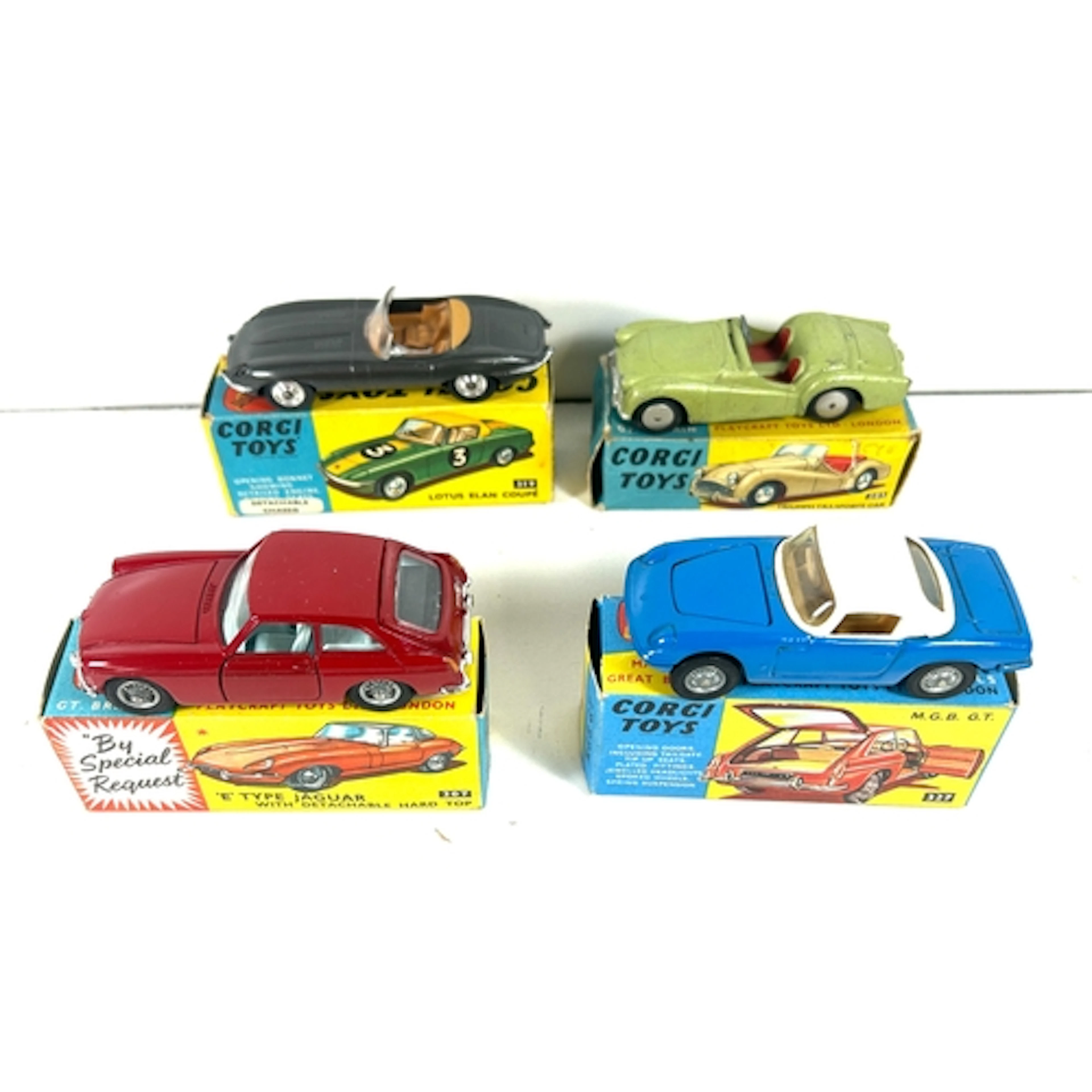 4 Corgi Toys. M.G.B. G.T. (327). In red with light blue inte...