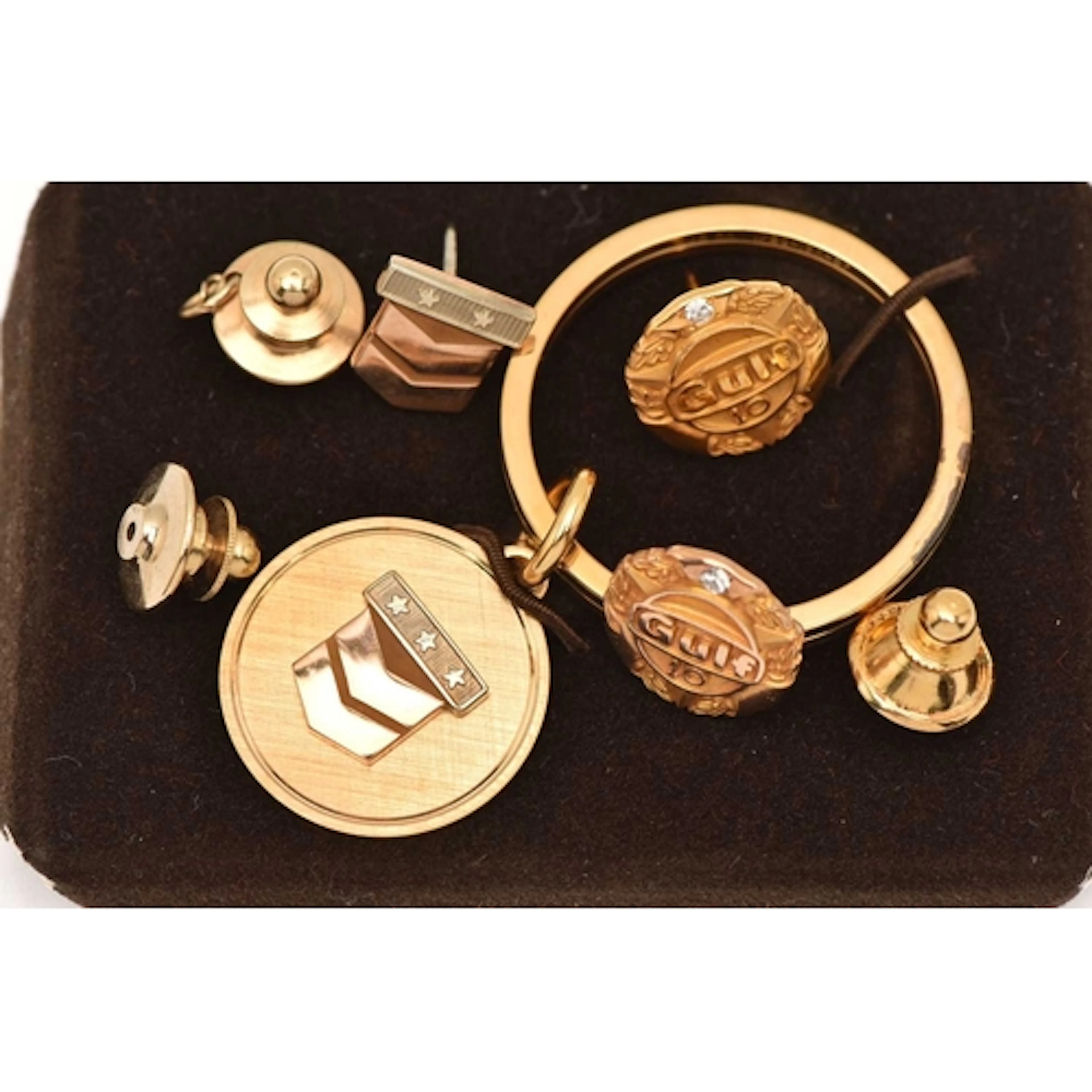 THREE YELLOW METAL PINS/BROOCH AND A KEYRING, to include a s...