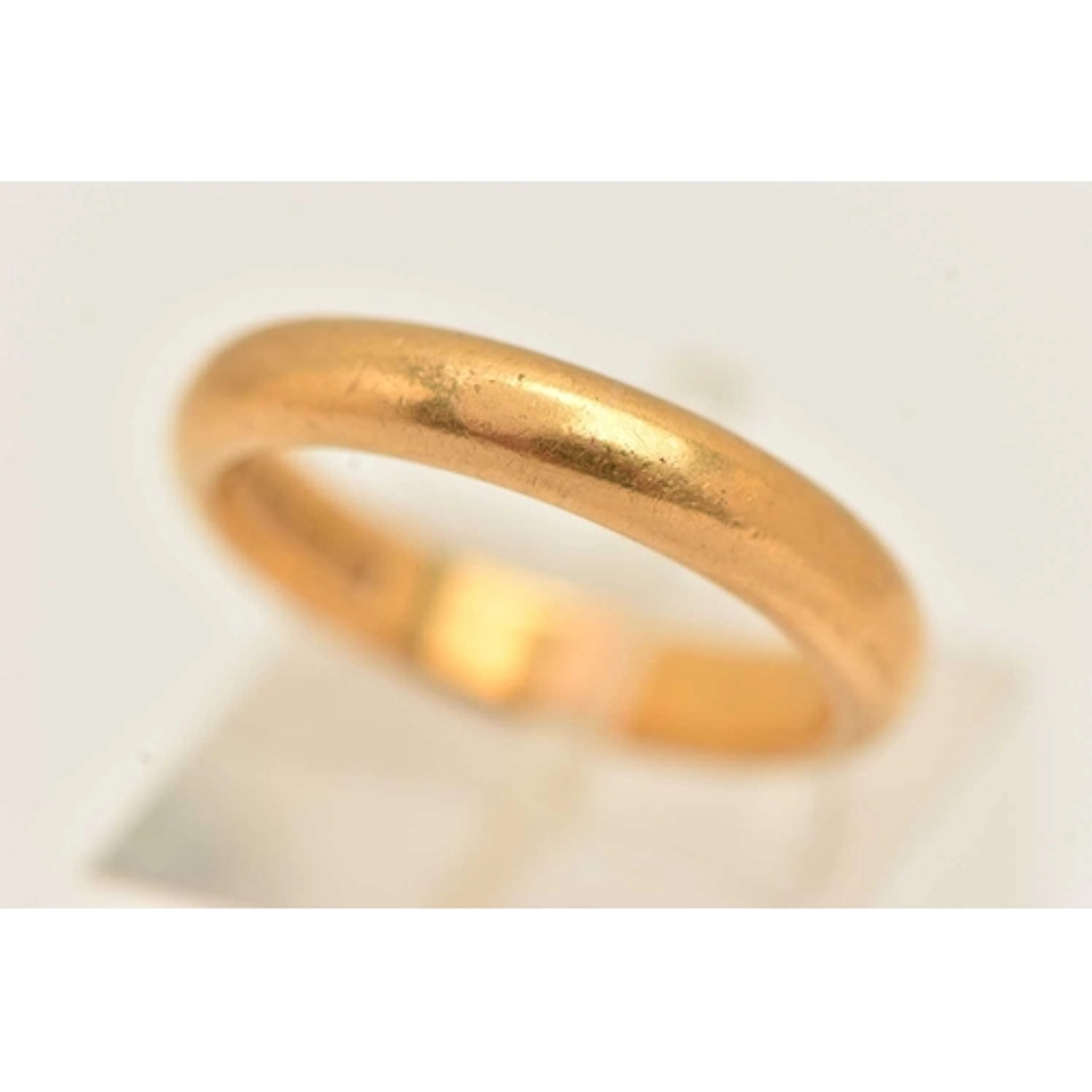 A 22CT GOLD BAND RING, approximate band width 3.6mm, hallmar...