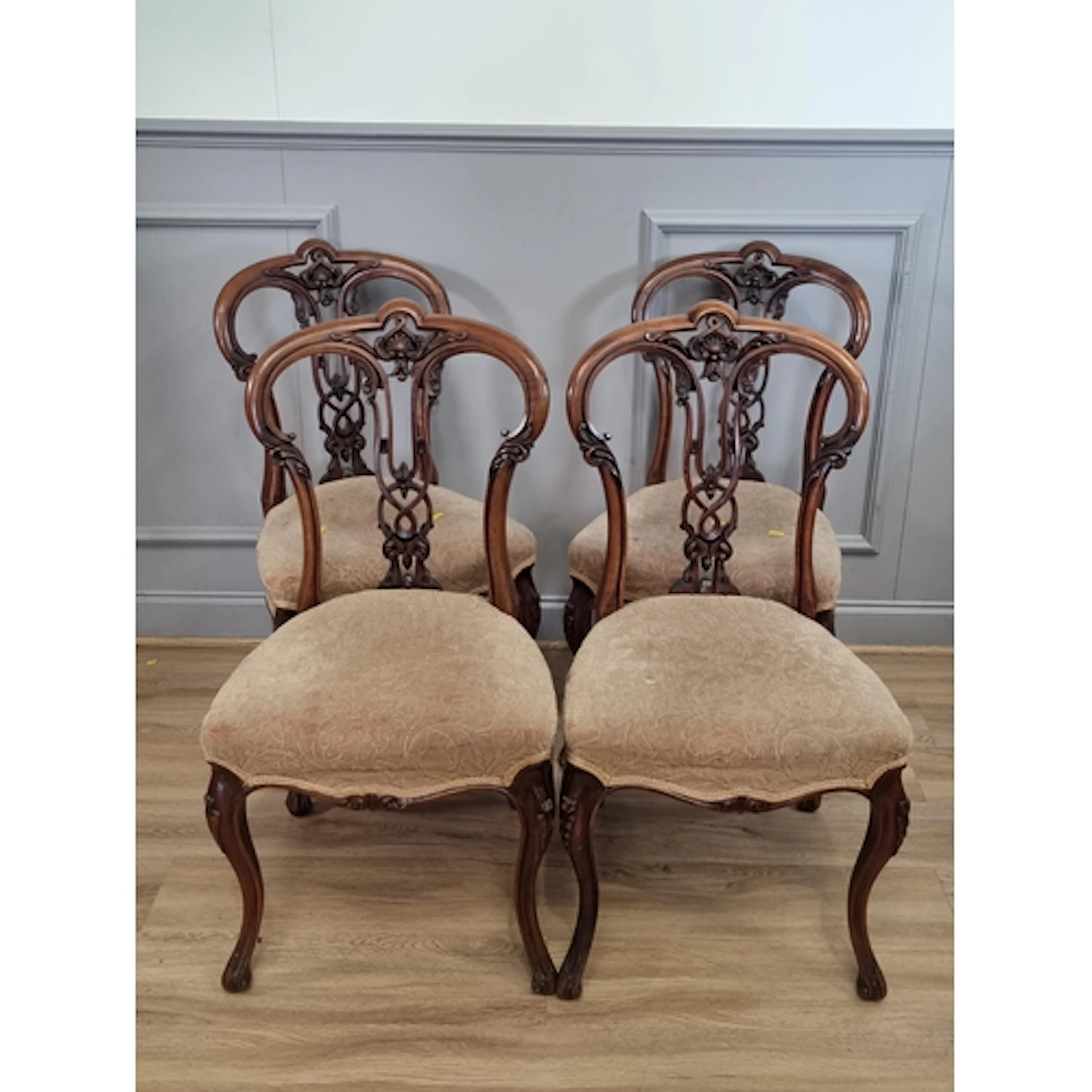 A set of four Victorian walnut Dining Chairs with carved pie...