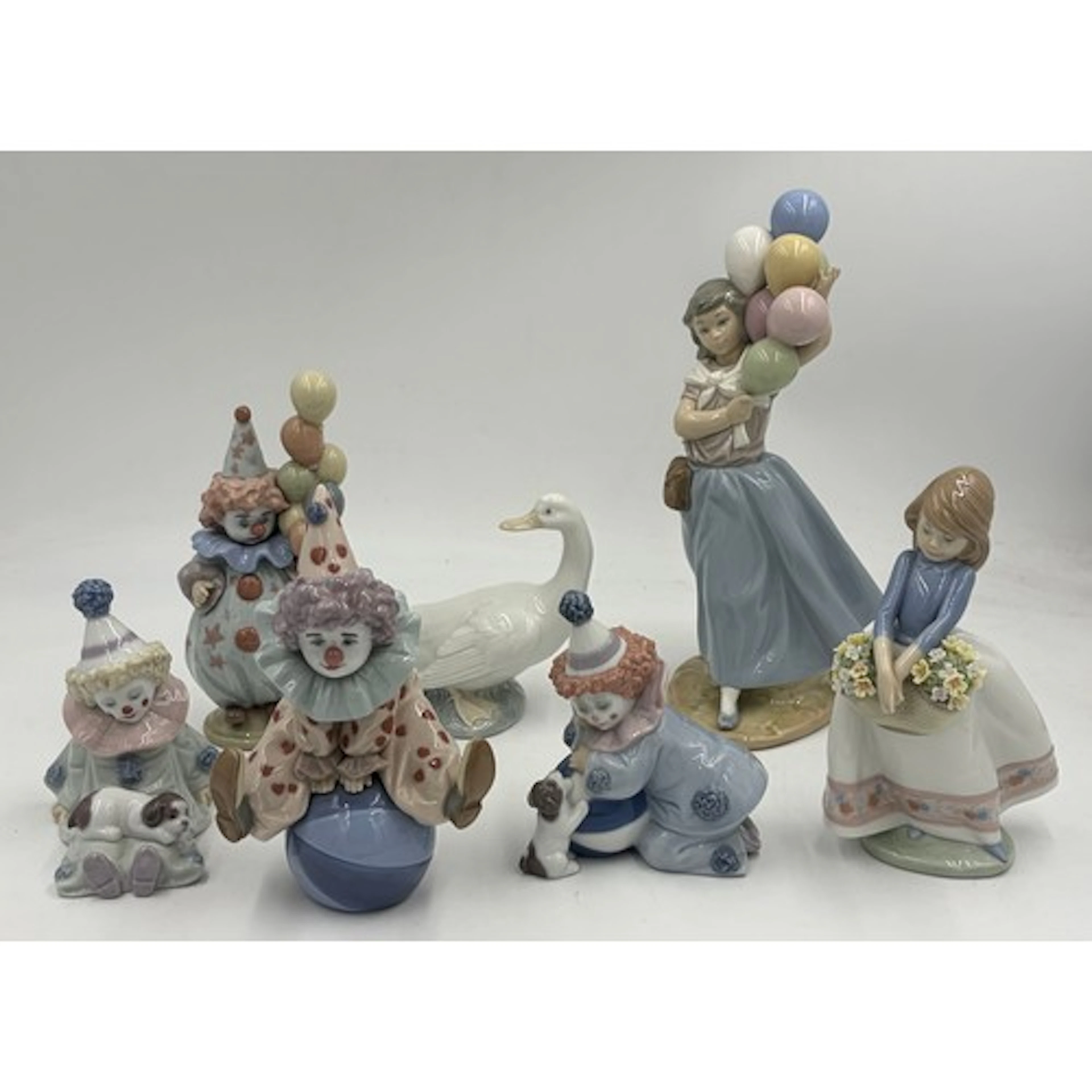 A group of Lladro figures comprising: Balloon Seller 5141, h...