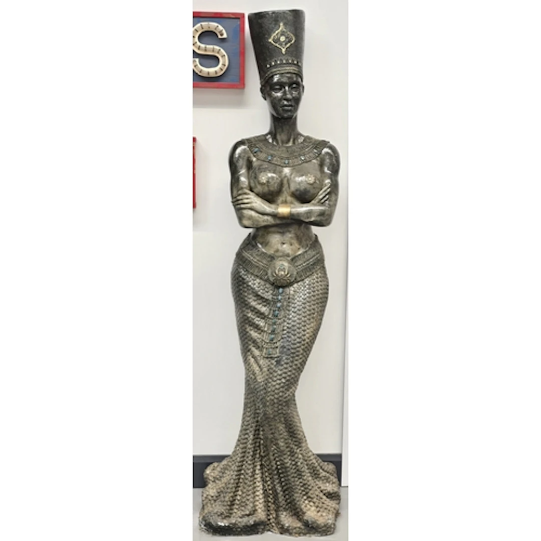 A large decorative floor statue in an Egyptian revival style...