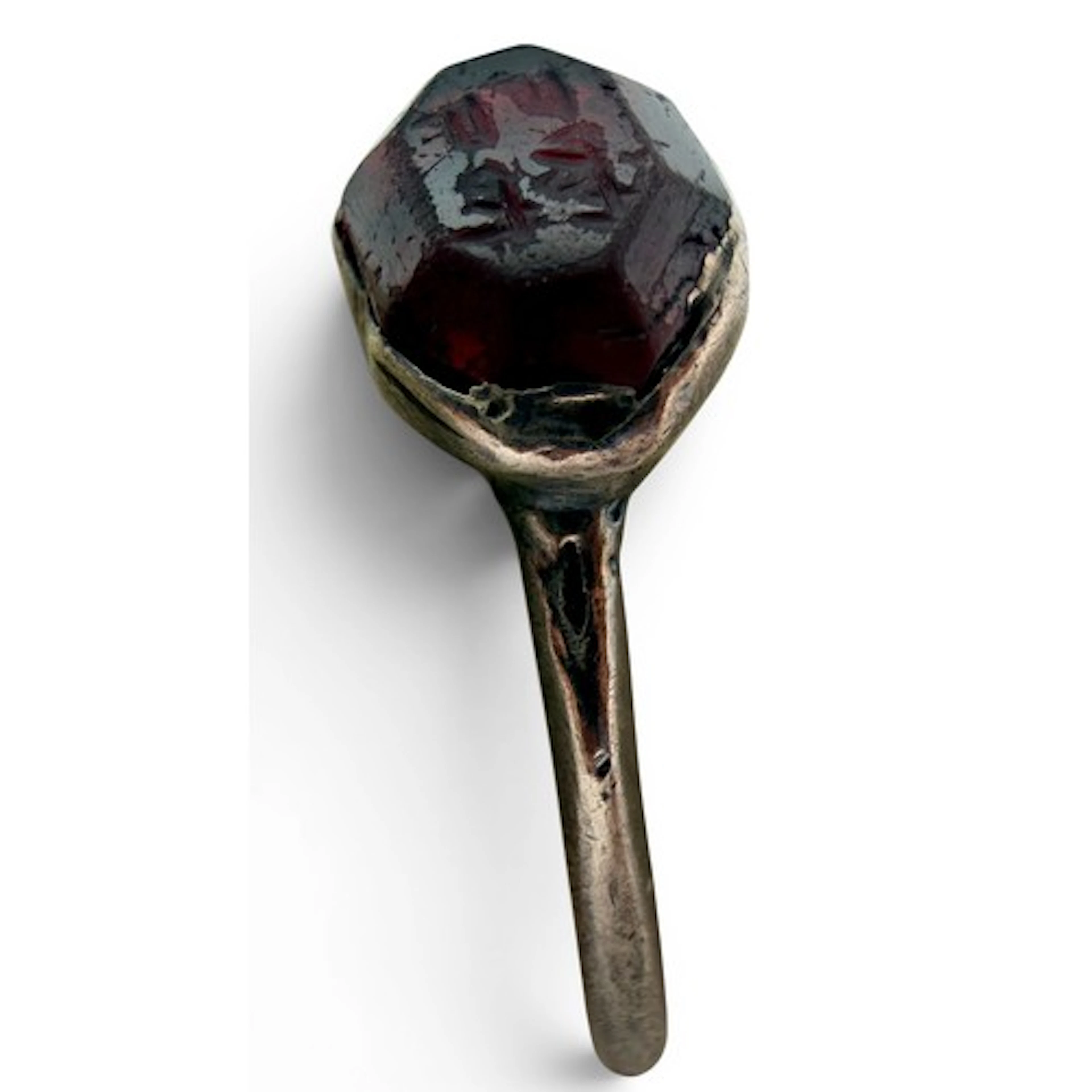 A silver ring set with a garnet intaglio bearing an Arabic o...
