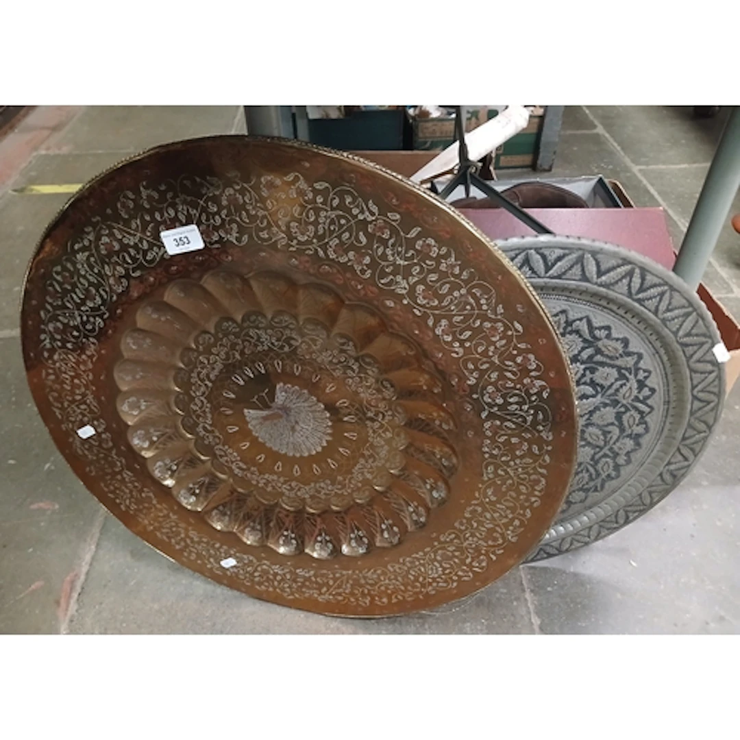 A large brass charger 9appx 60cm diameter) with an embossed ...