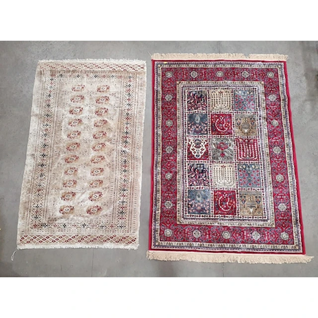 A modern red ground Rug with multi floral borders the centre...