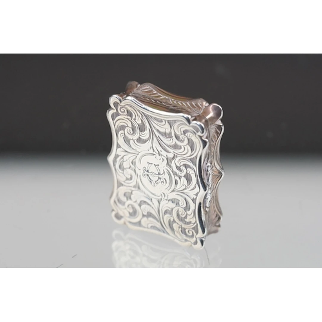 Victorian silver foliate engraved vinaigrette, the central c...