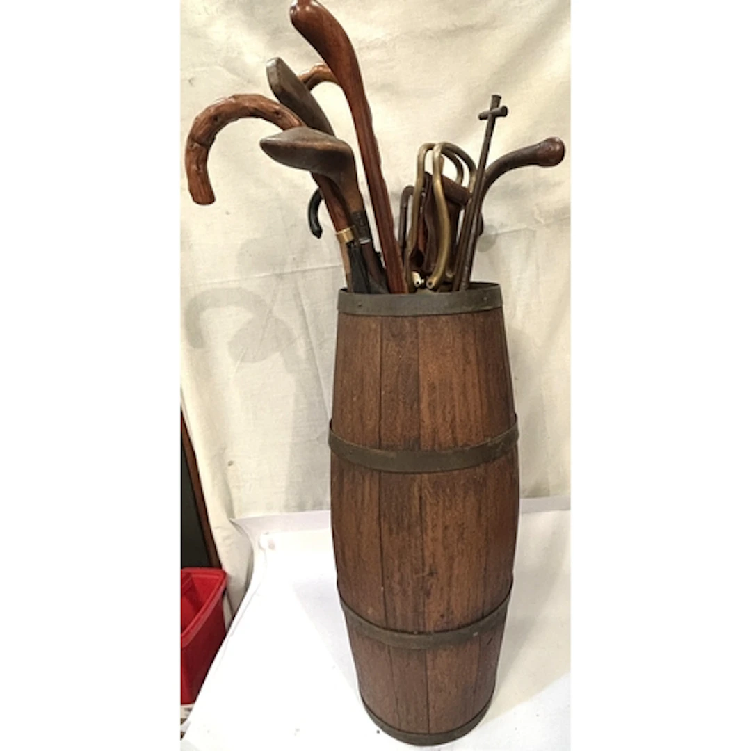 A 19th century brass bound barrel stick stand with contents,...
