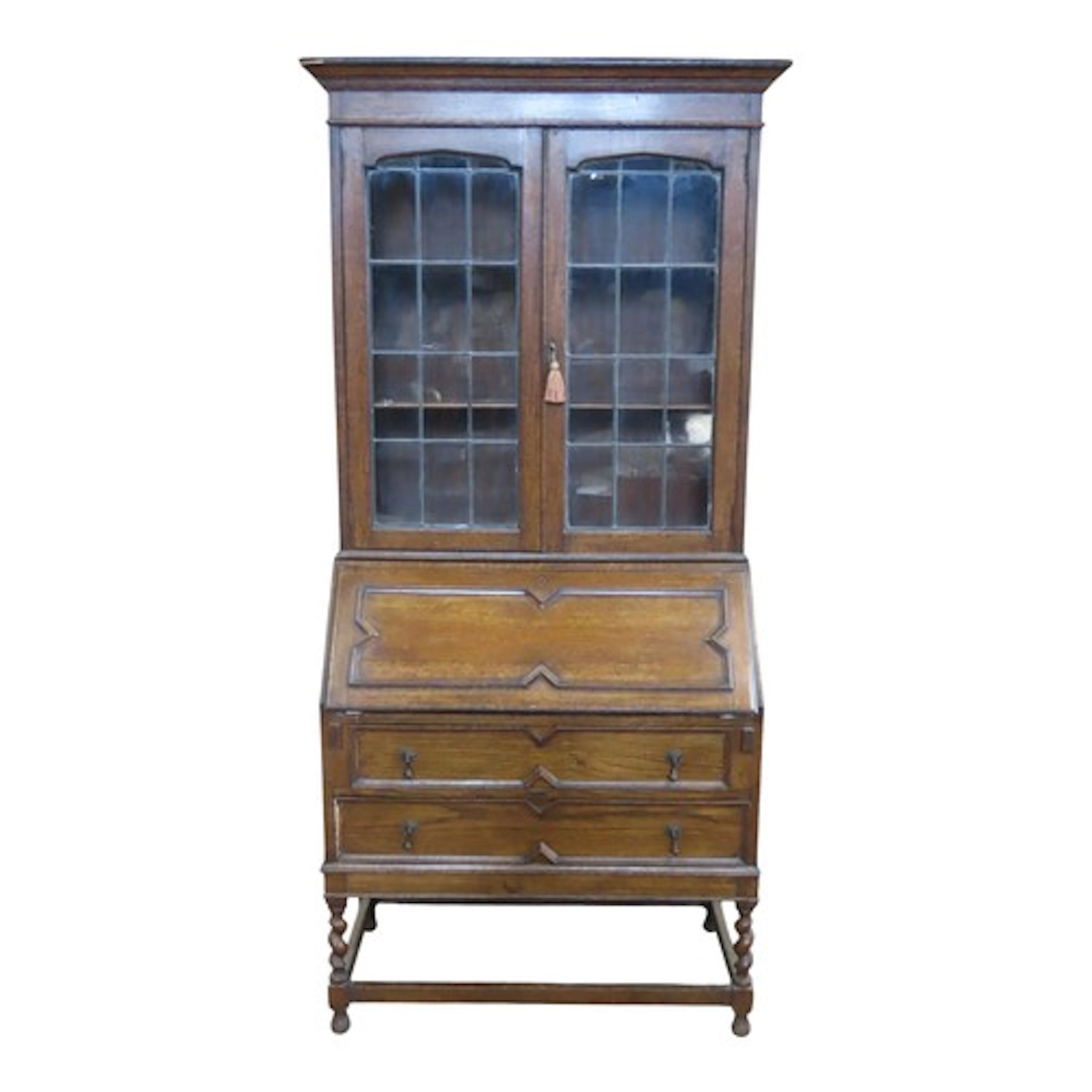 A 1920's Jacobean revival oak bureau bookcase with applied g...