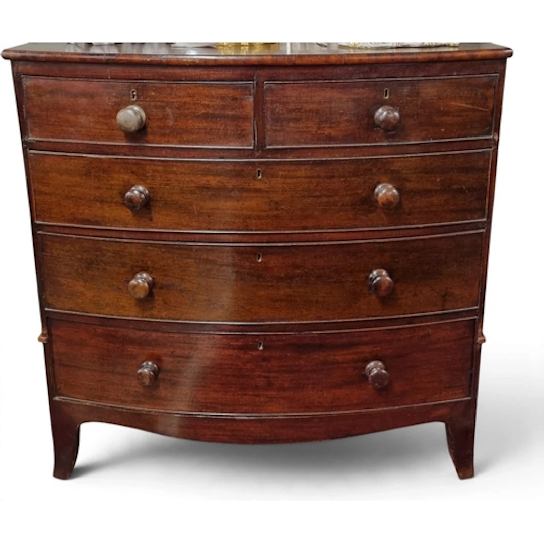 A 19th Century bow fronted Chest of Drawers with original Ti...