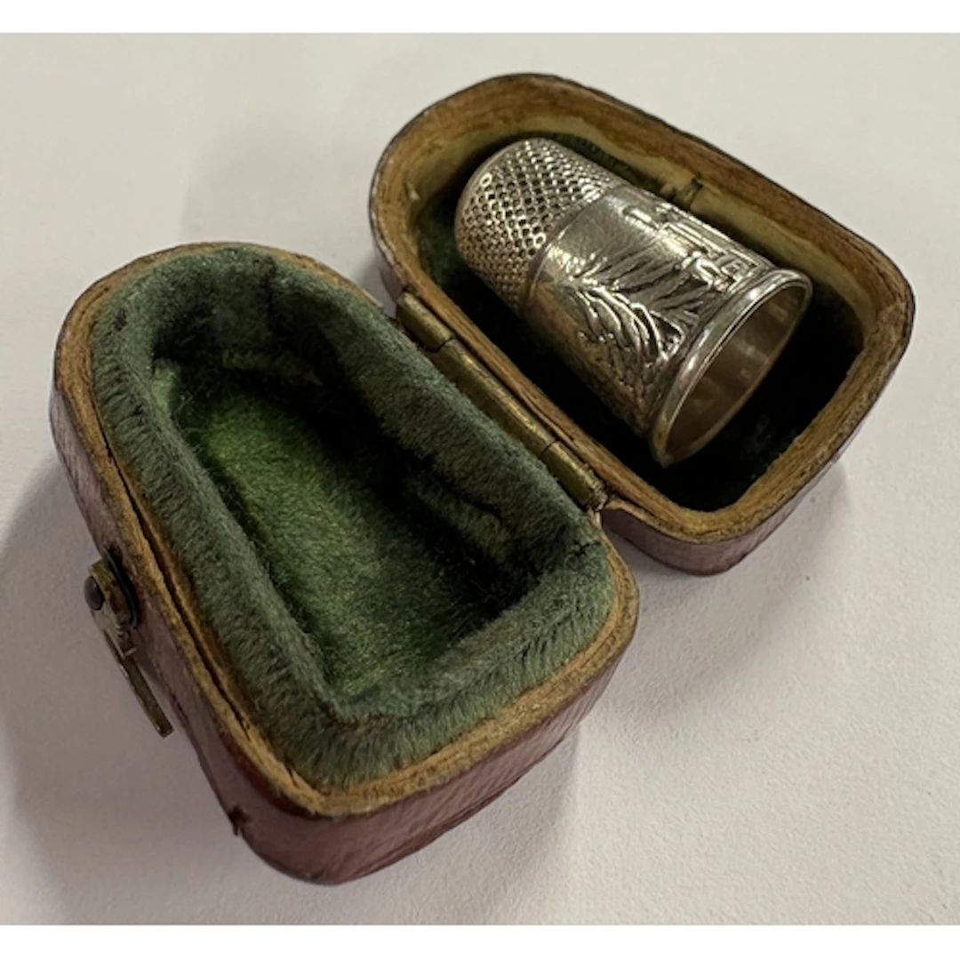 A novelty Victorian silver castle top thimble contained with...