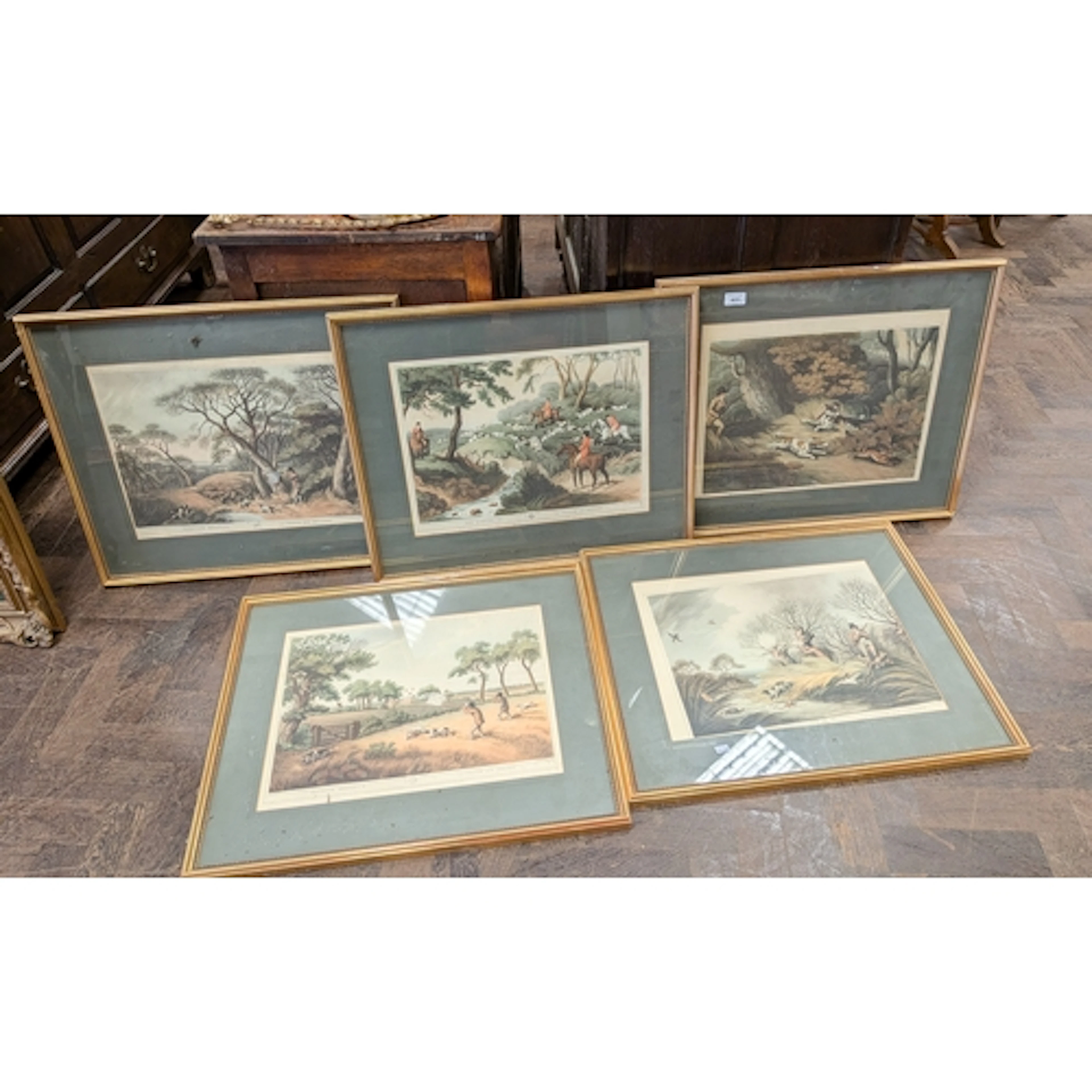 Five coloured prints of 18th century hunting scenes, glazed,...