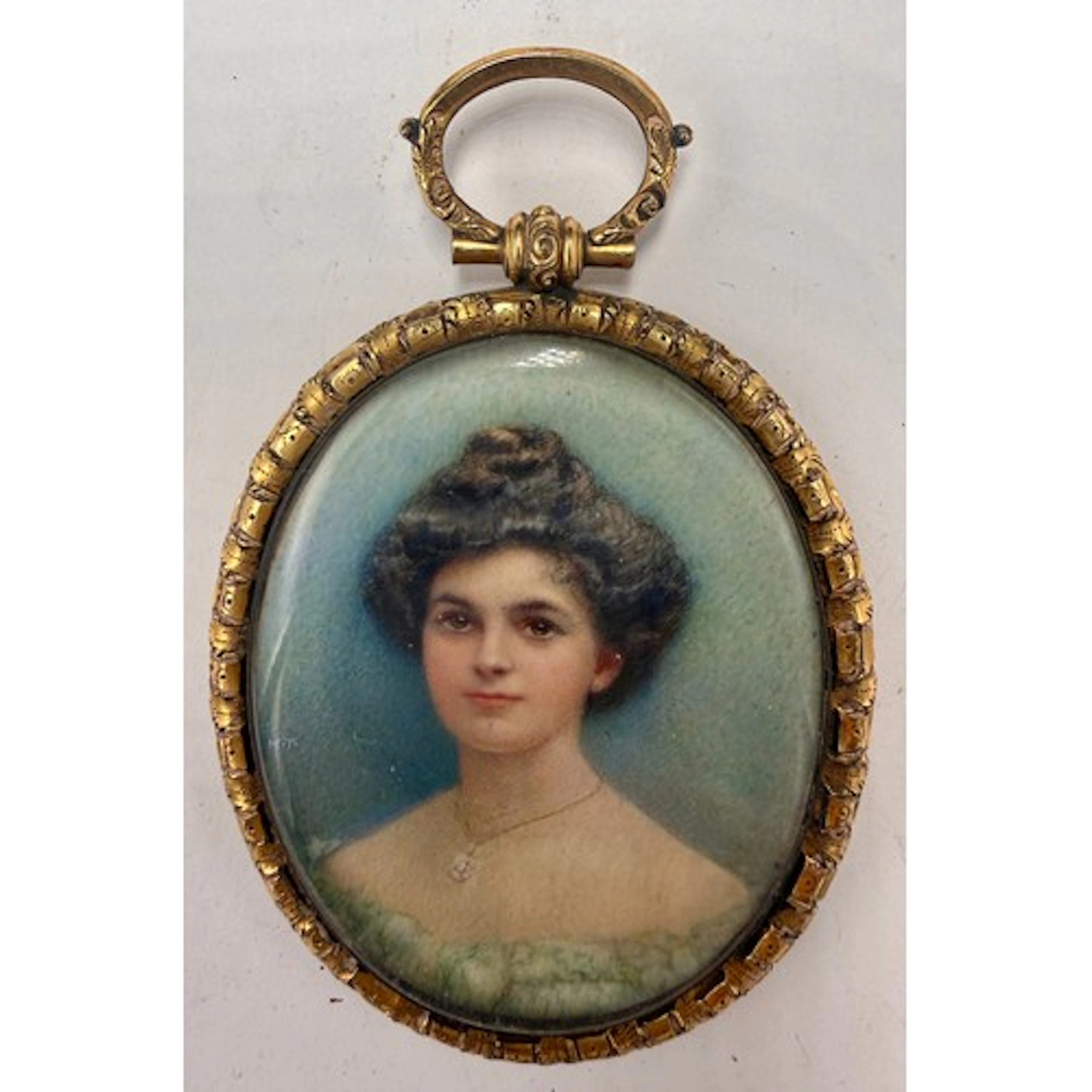 A miniature painting on ivory in an oval gilt metal frame wi...