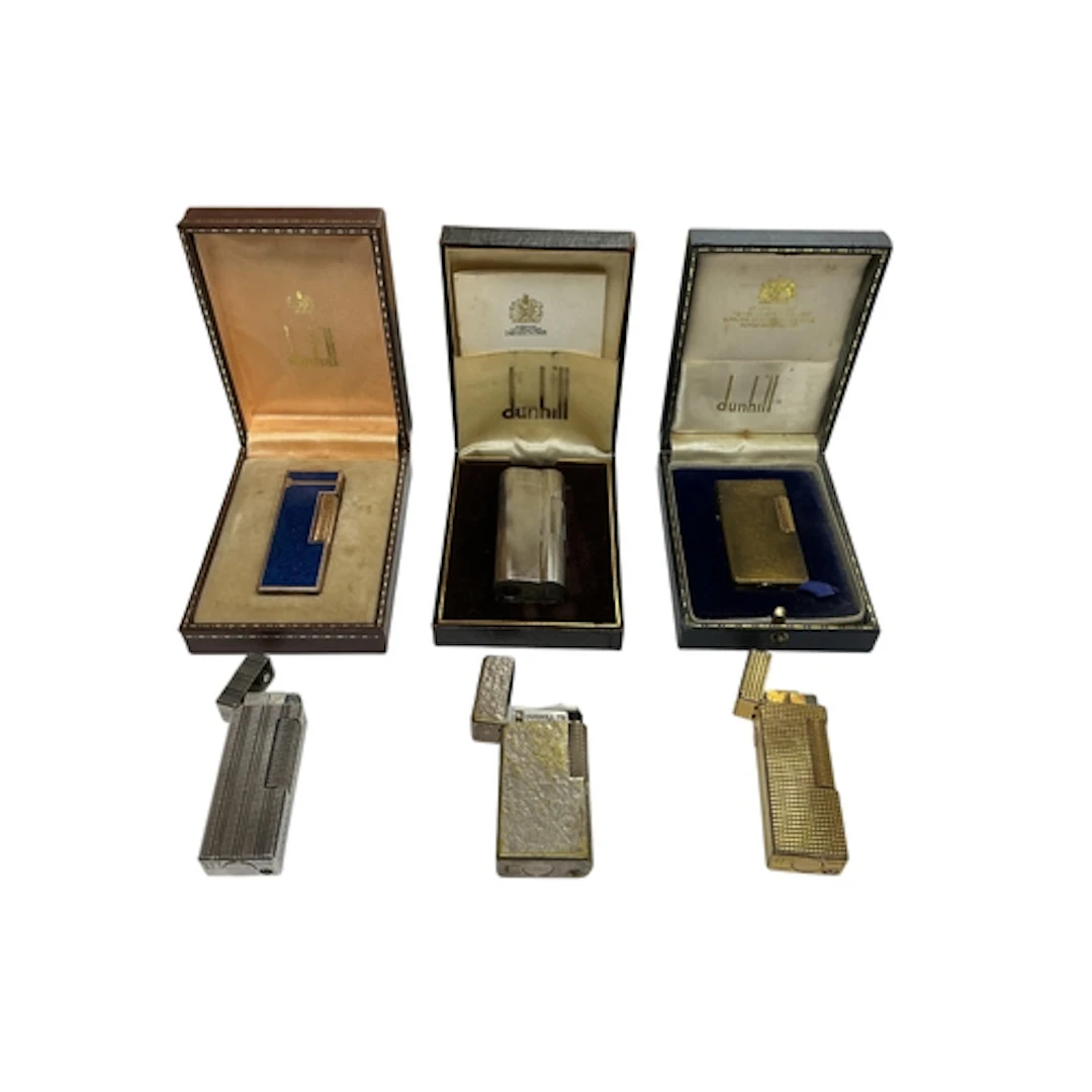 A collection of six Dunhill lighters, one with blue enamel d...
