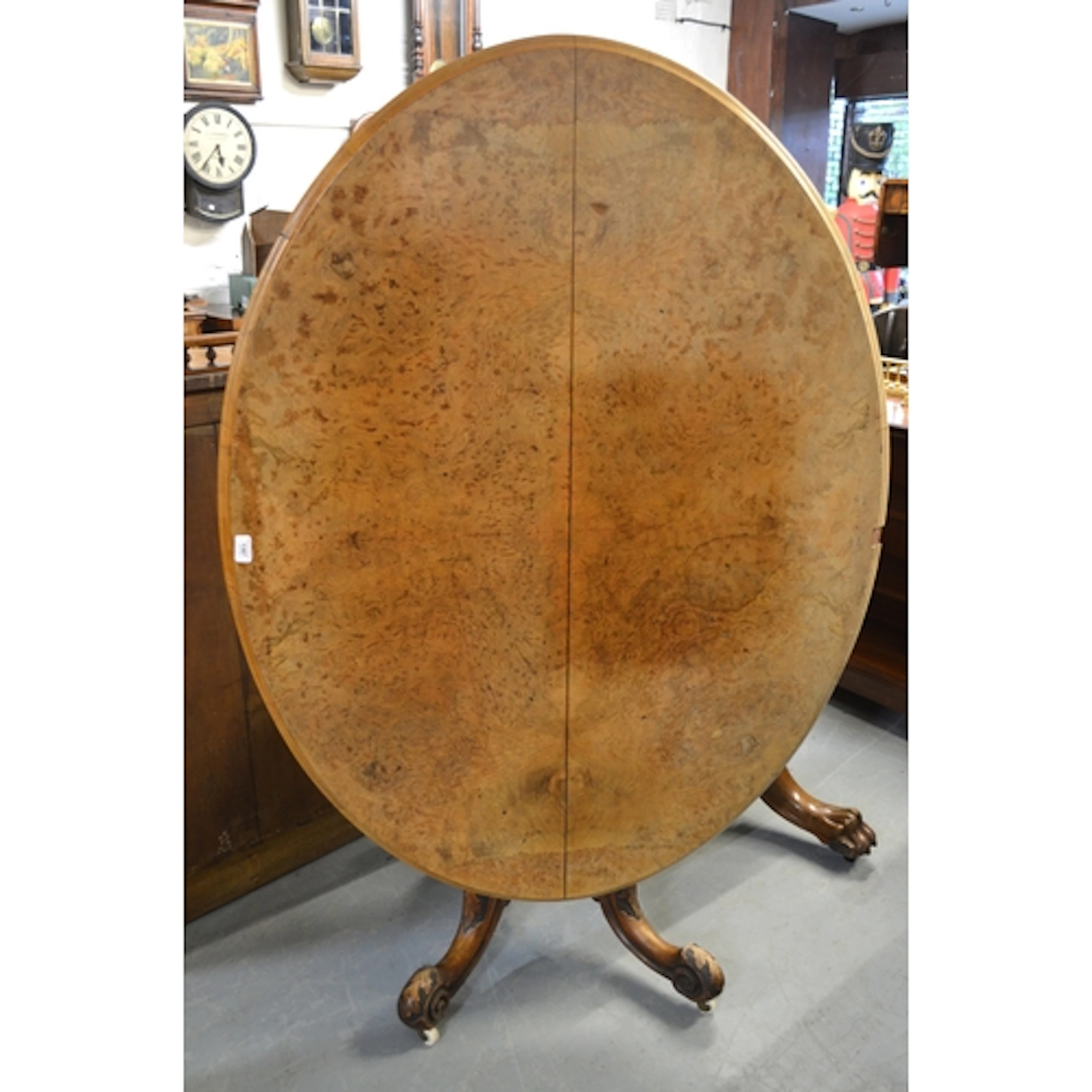 Victorian figured walnut oval centre table, on a turned and ...