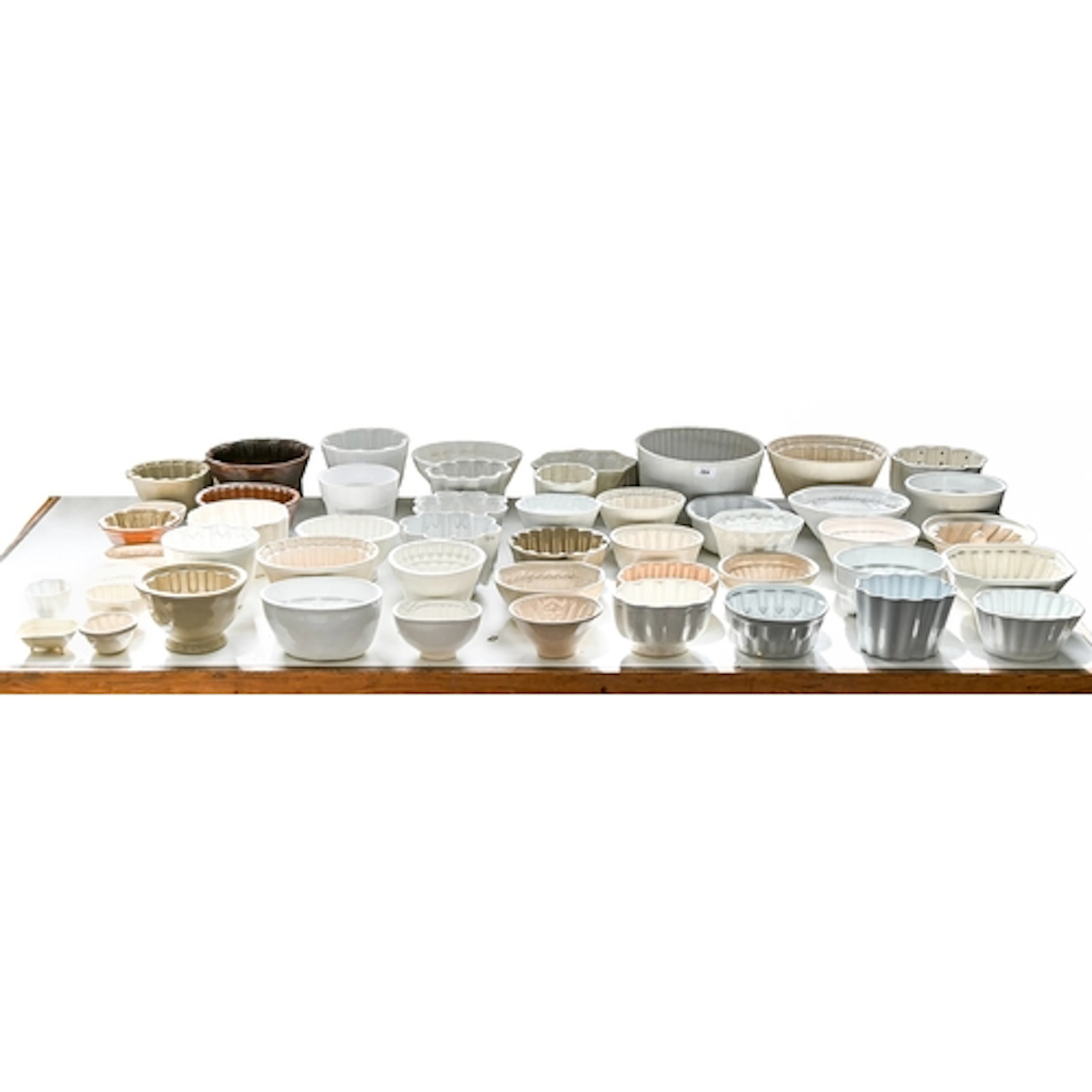 A collection of earthenware and salt-glazed stoneware jelly ...