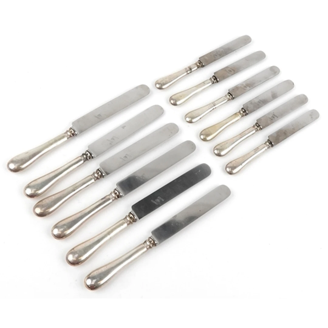 Two sets of six German knives having silver cased handles an...