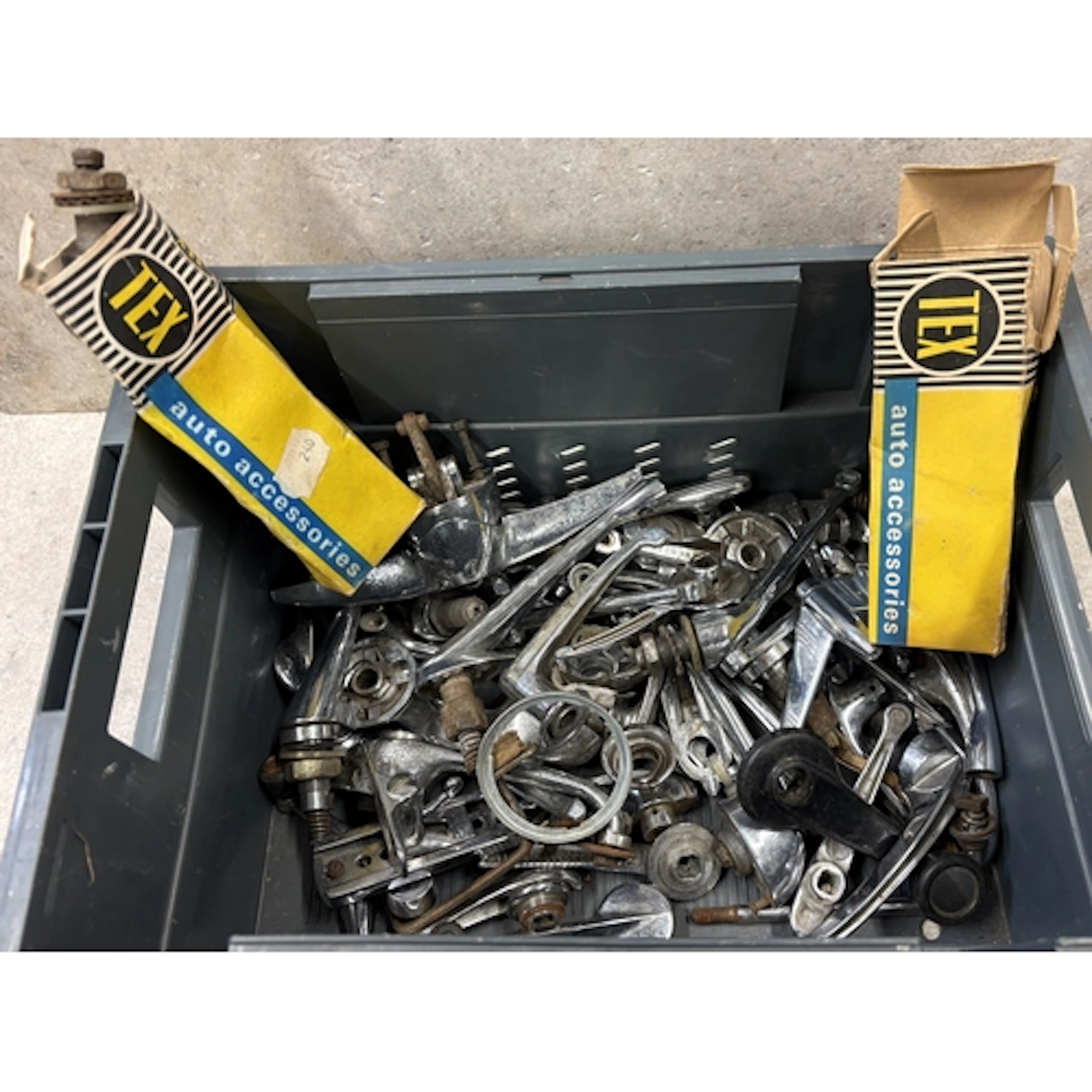 A collection of chrome window winders, door handles and mirr...