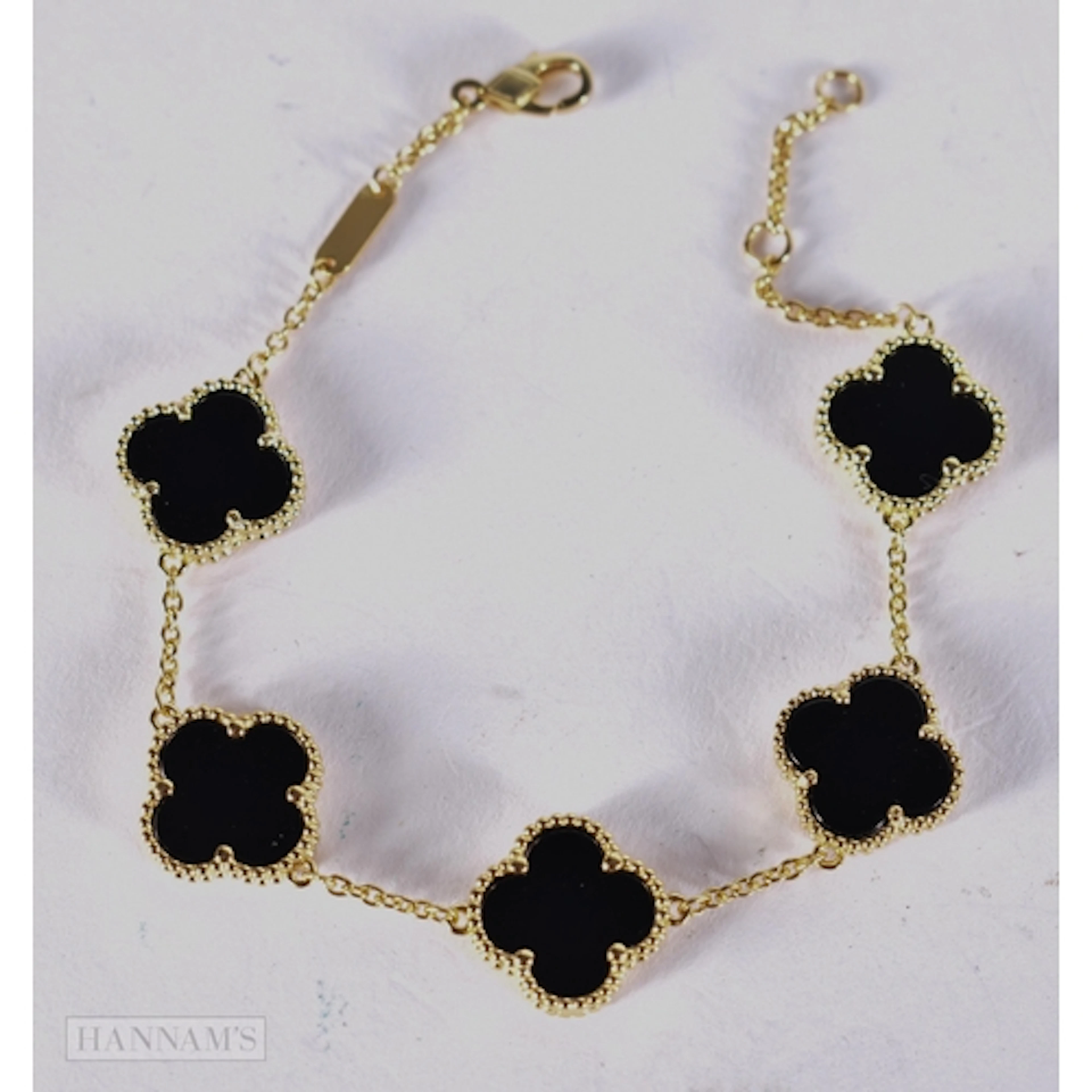 A SILVER GILT AND BLACK ONYX CLOVER BRACELET. 20 cm. 7.7 gra...