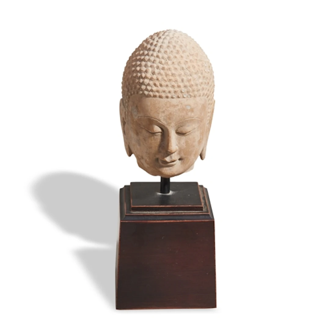 A CARVED STONE HEAD OF BUDDHA 19TH / 20TH CENTURY In the G...