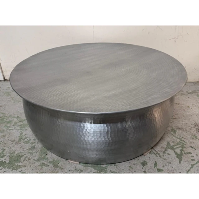 An industrial style white hammered metal circular coffee tab...