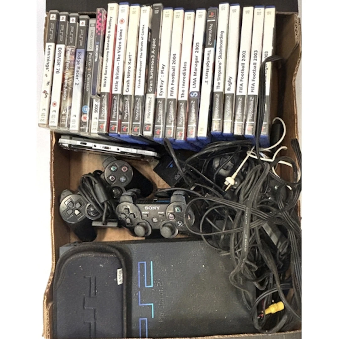 PlayStation 2 with games, eye toy control panel and memory c...