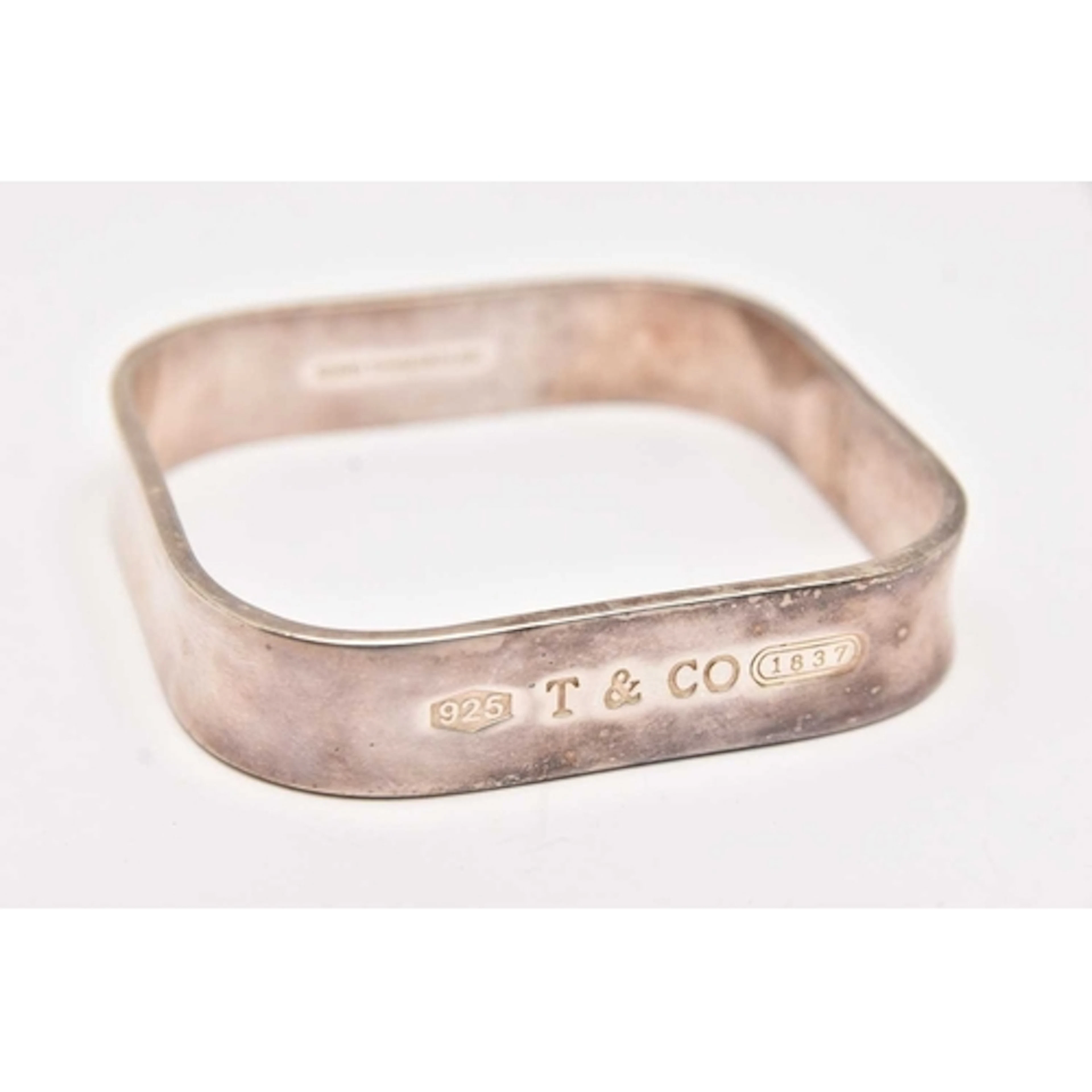 A 'TIFFANY & CO' SQUARE BANGLE, stamped to the outer ban...