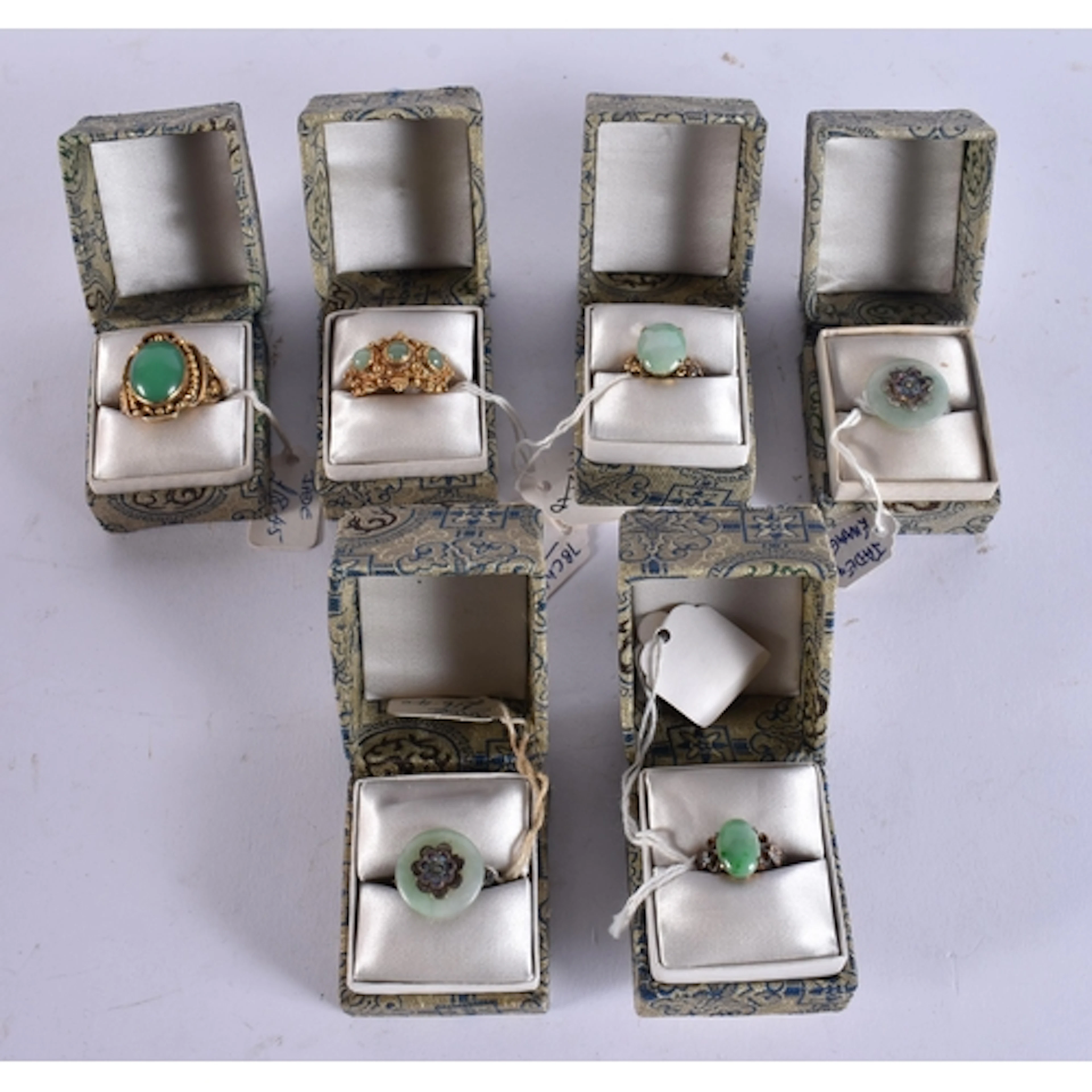 SIX CHINESE SILVER AND JADE RINGS in various forms and sizes...