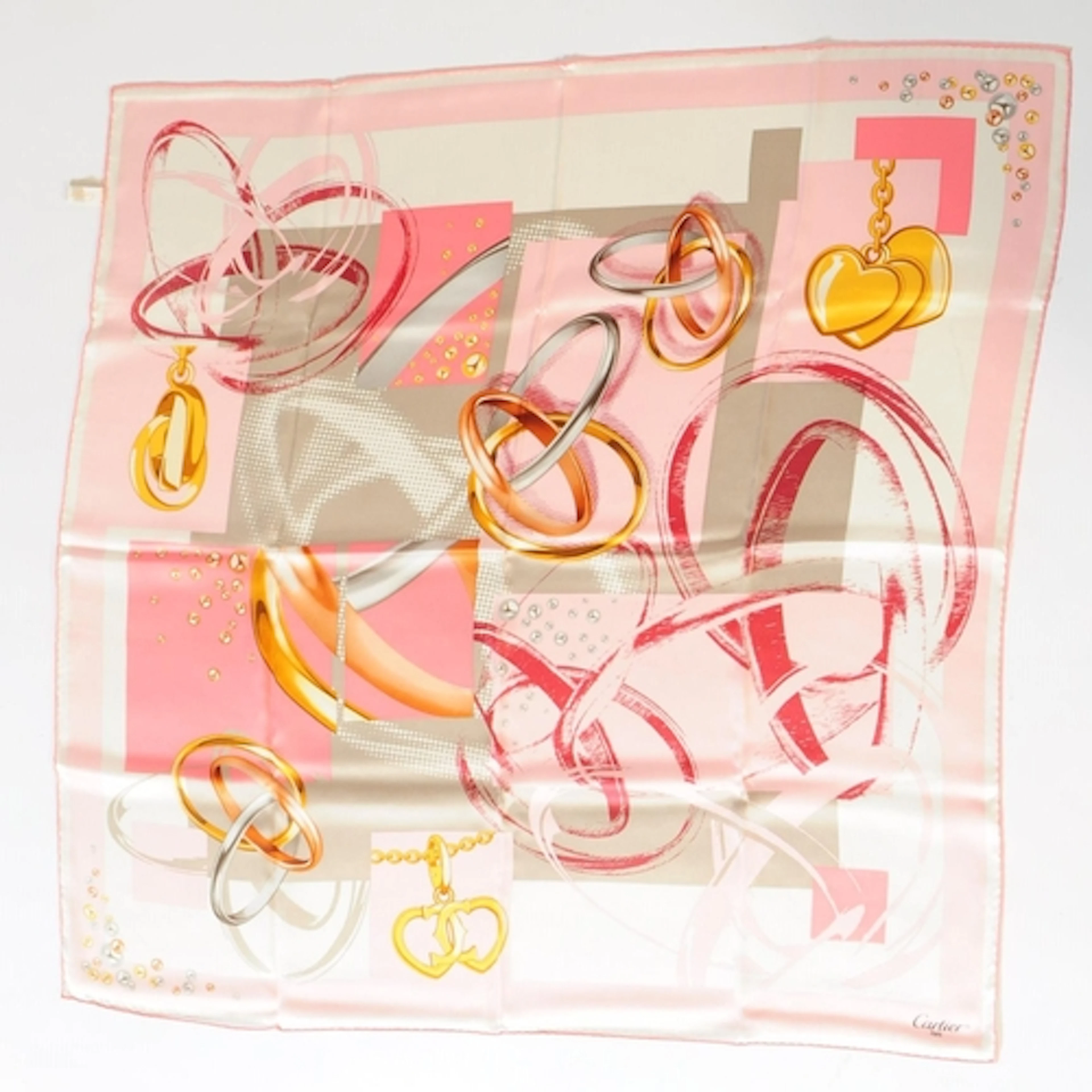 A Cartier Trinity ring printed silk scarf. The scarf printed...