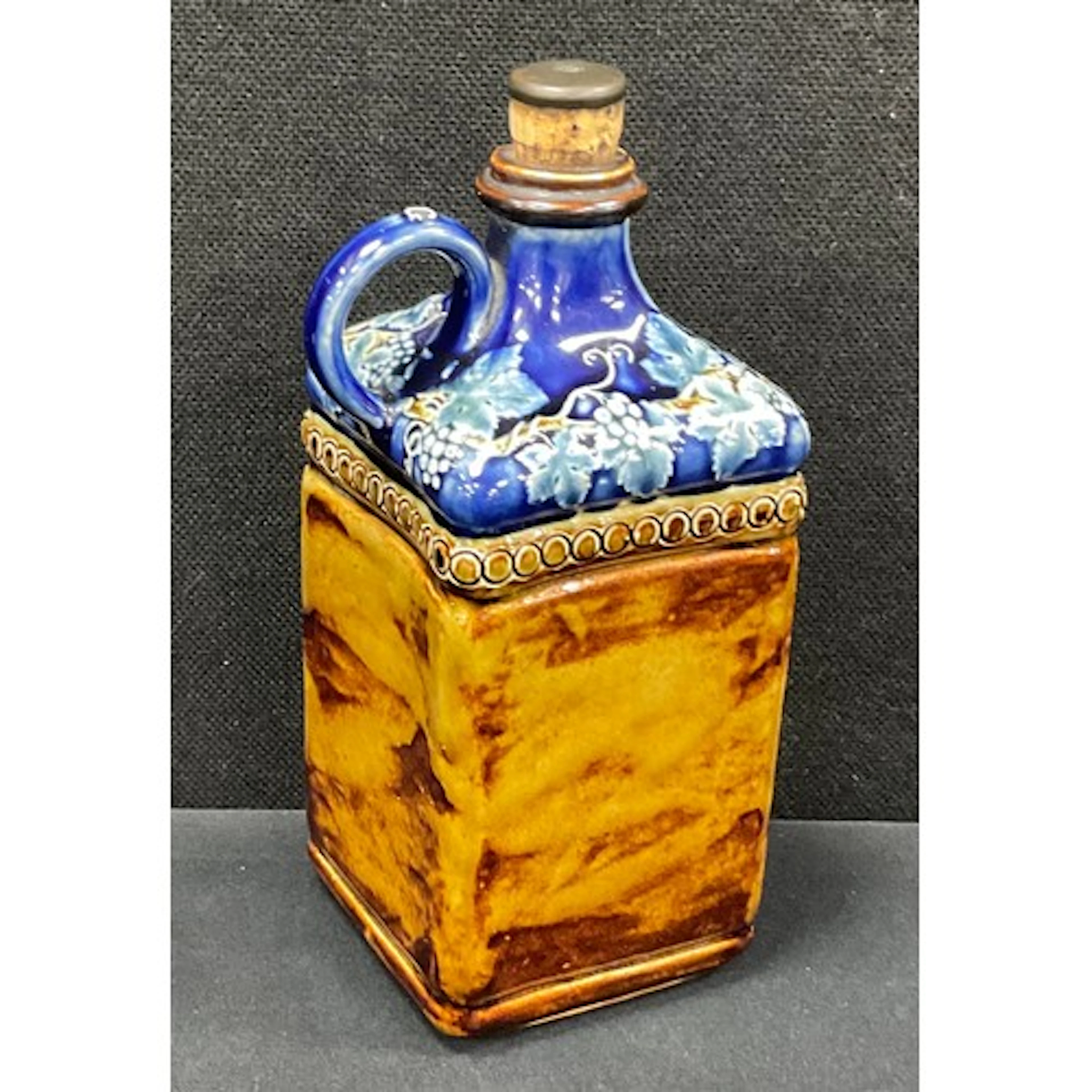 A Victorian Doulton Lambeth stoneware spirit flask, the squa...