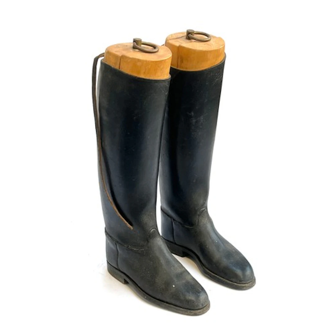 A pair of black leather hunting boots with beechwood trees, ...