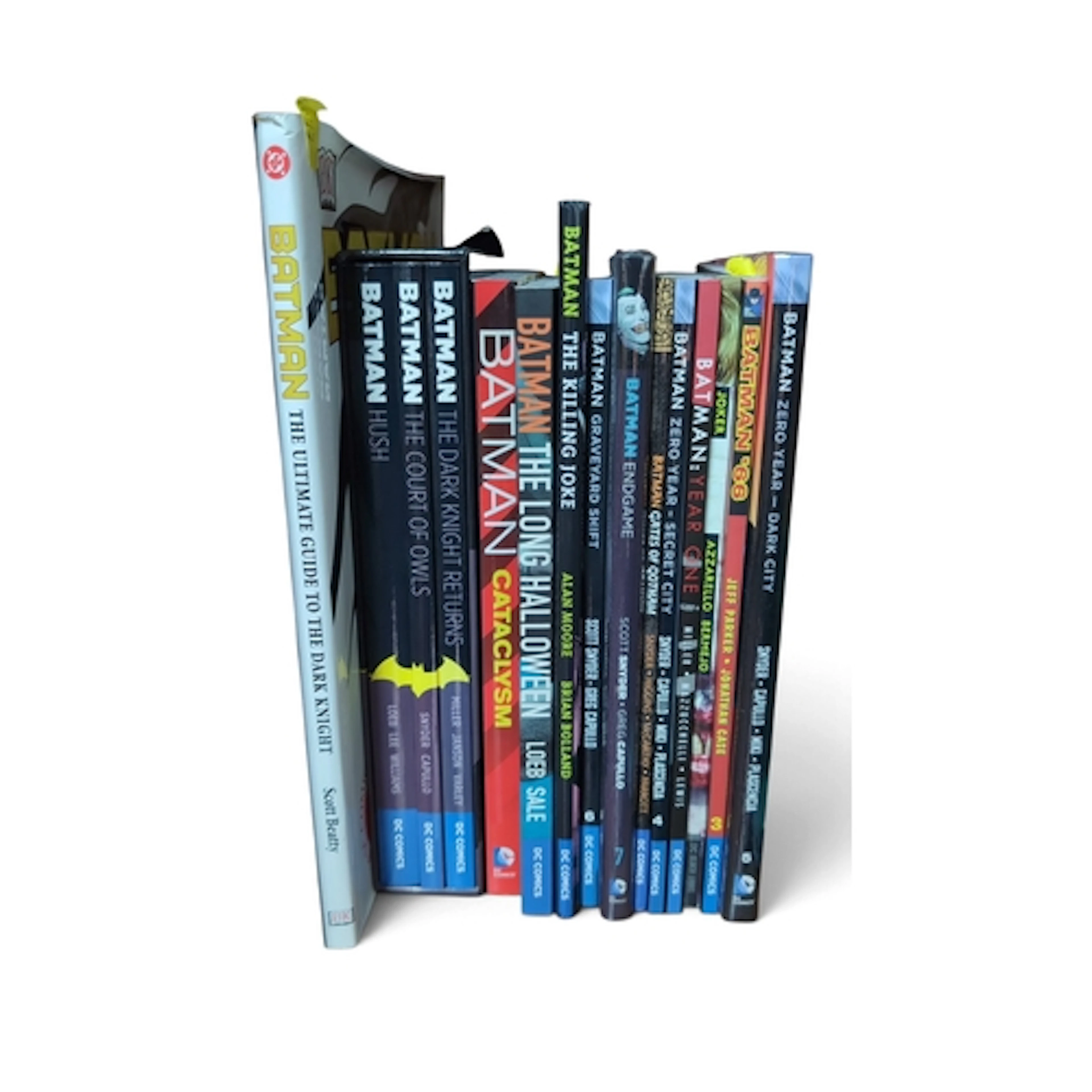 A collection of Batman graphic novels and reference books, i...