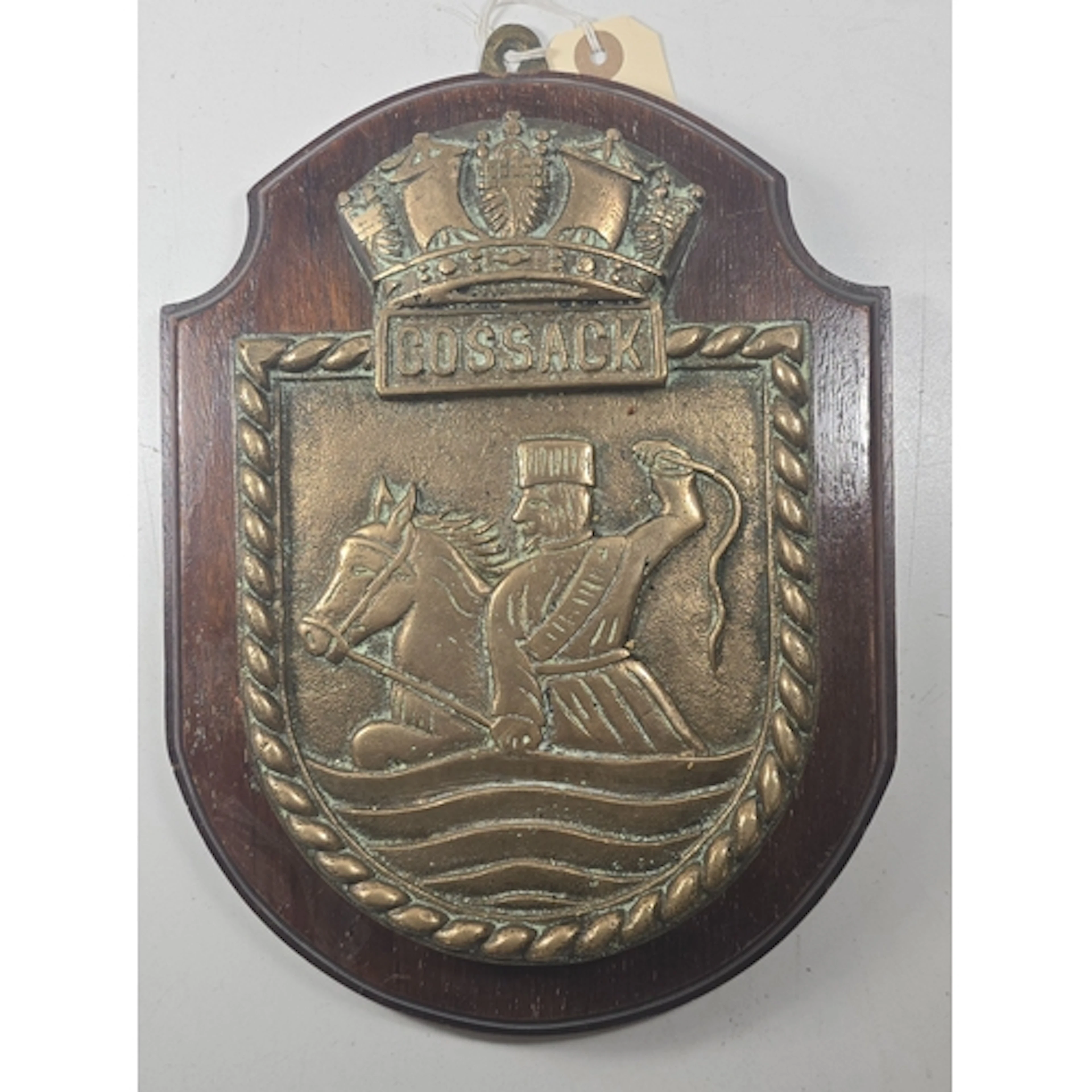 A heavy cast brass ship’s escutcheon of HMS COSSACK, 21.5cms...
