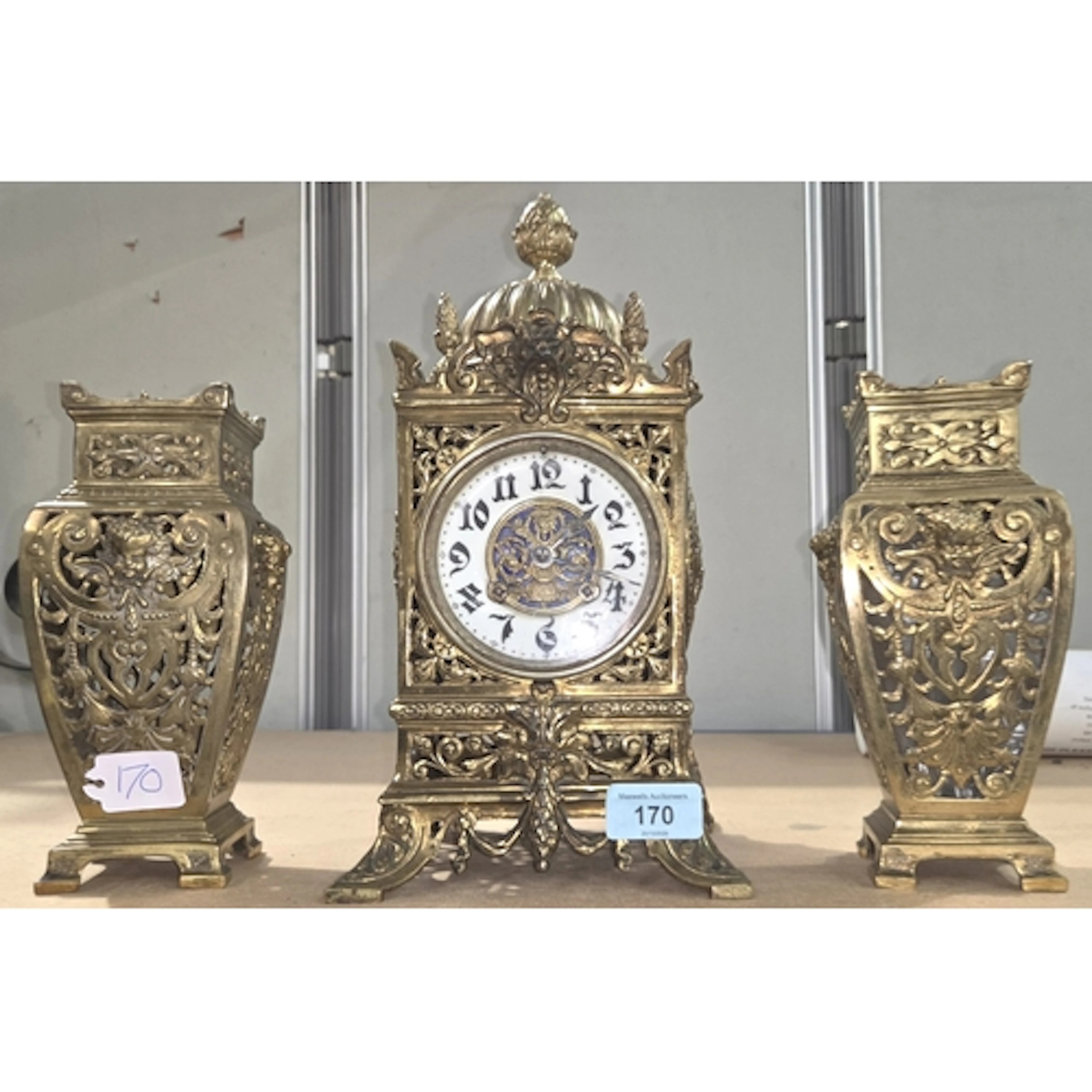 An early 20th century brass clock garniture with pierced bra...