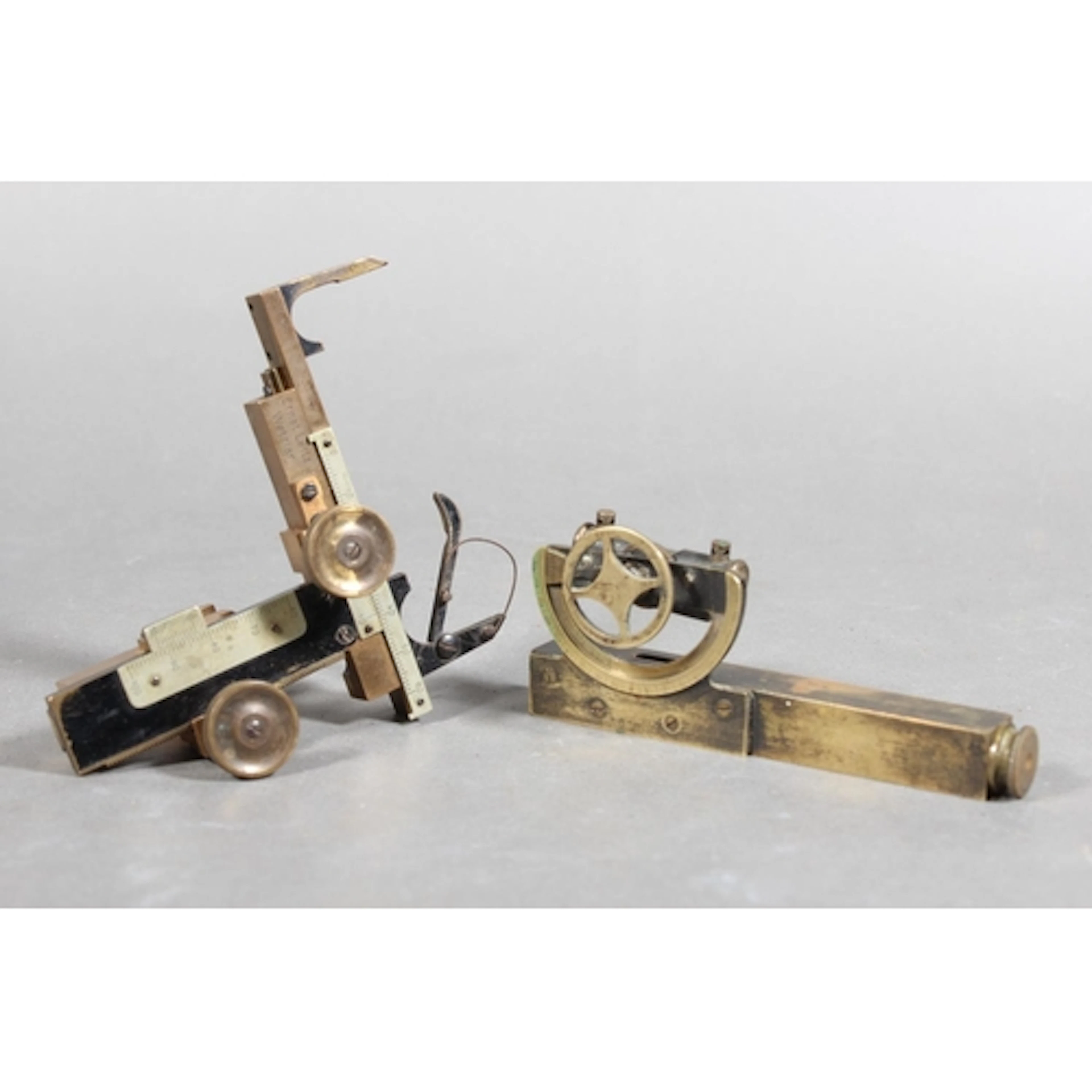 Surveyor's pocket inclinometer gauge held in brown leather c...