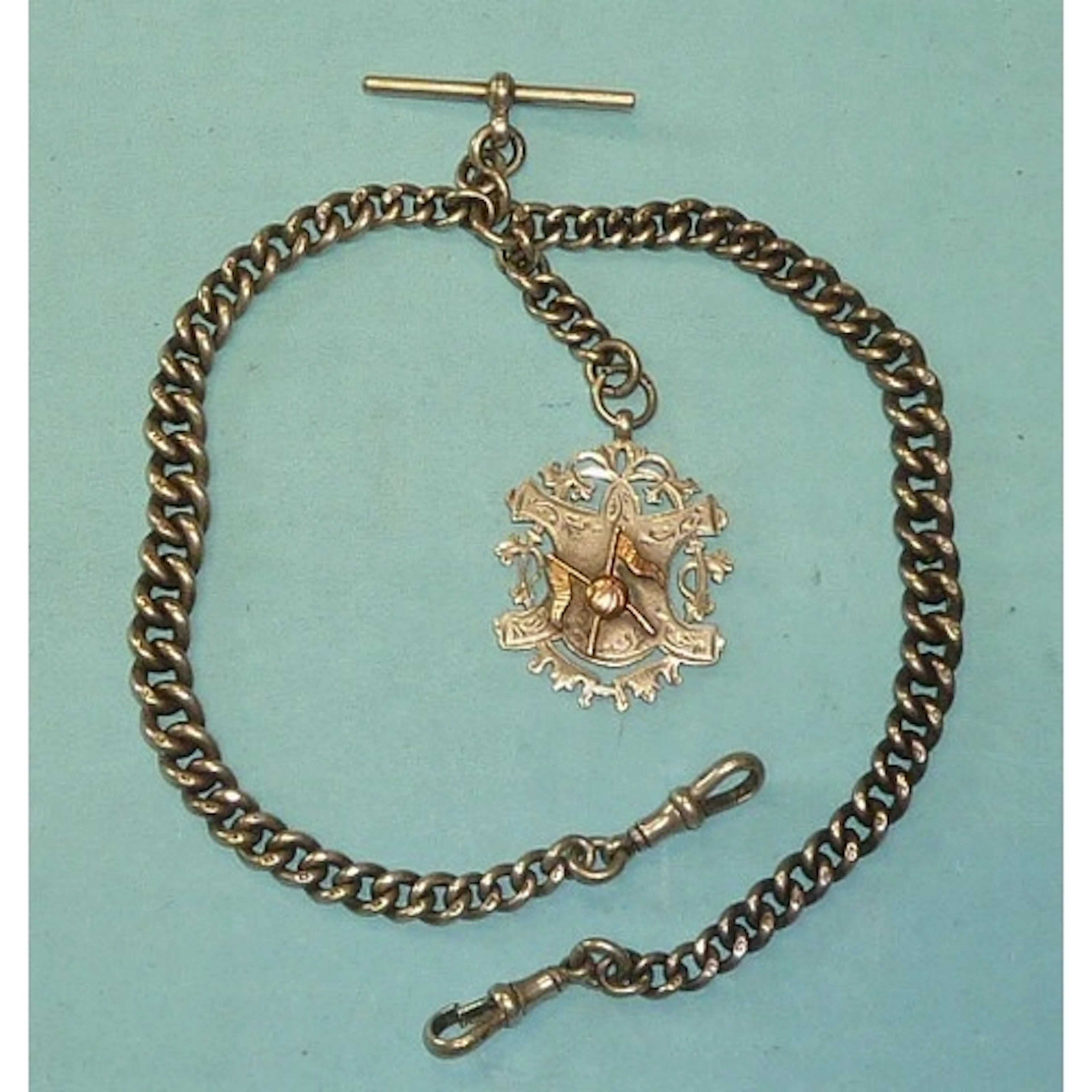 A silver graduated curb-link Albert watch chain with silver ...