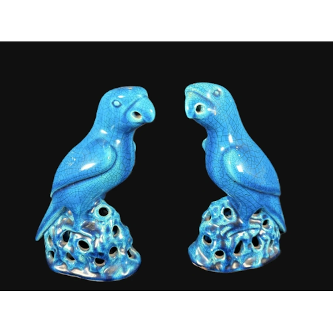 A pair of crackle glaze turquoise glazed figures of parrots ...