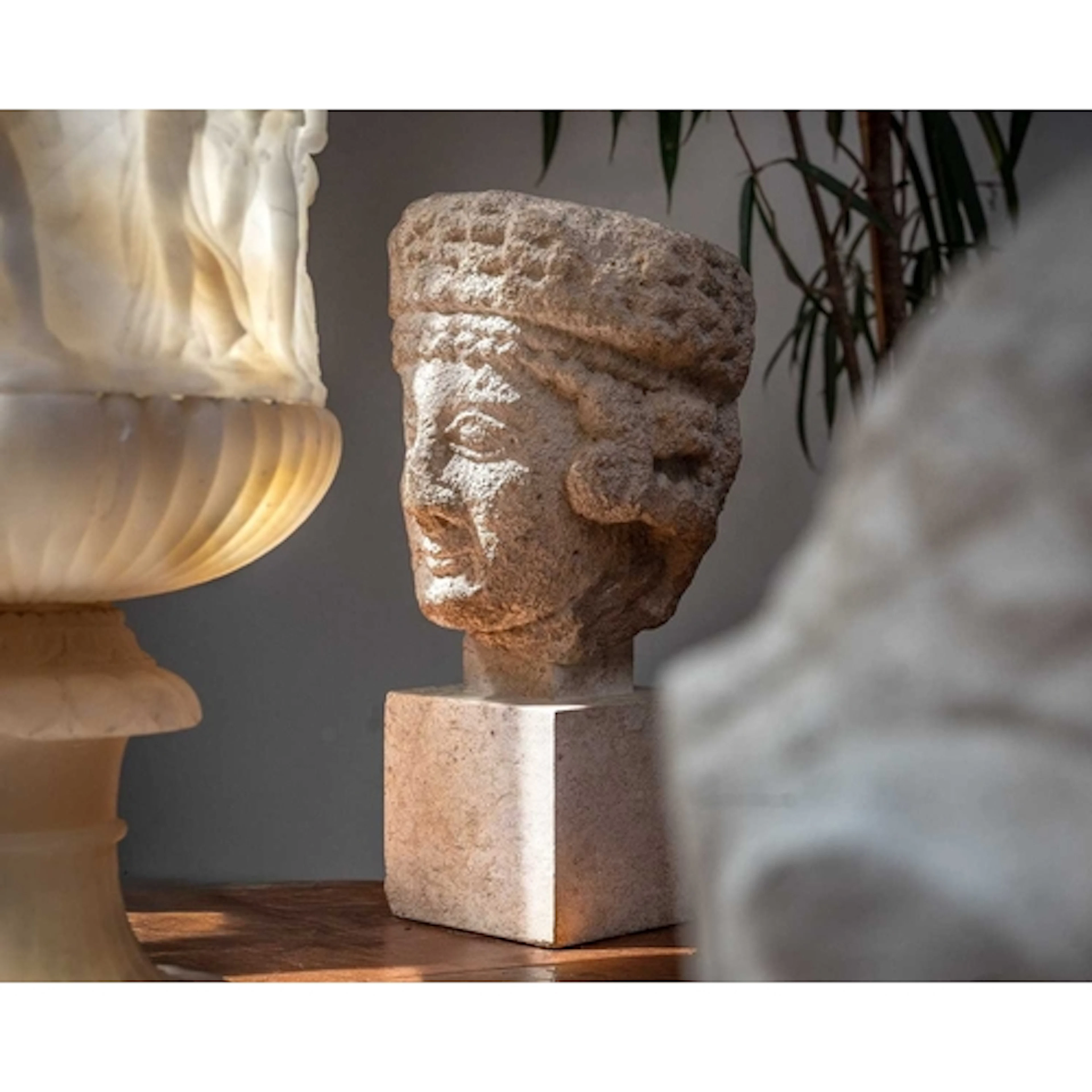 A Cypriot limestone head of a female Votary. Archaic, 5th ce...