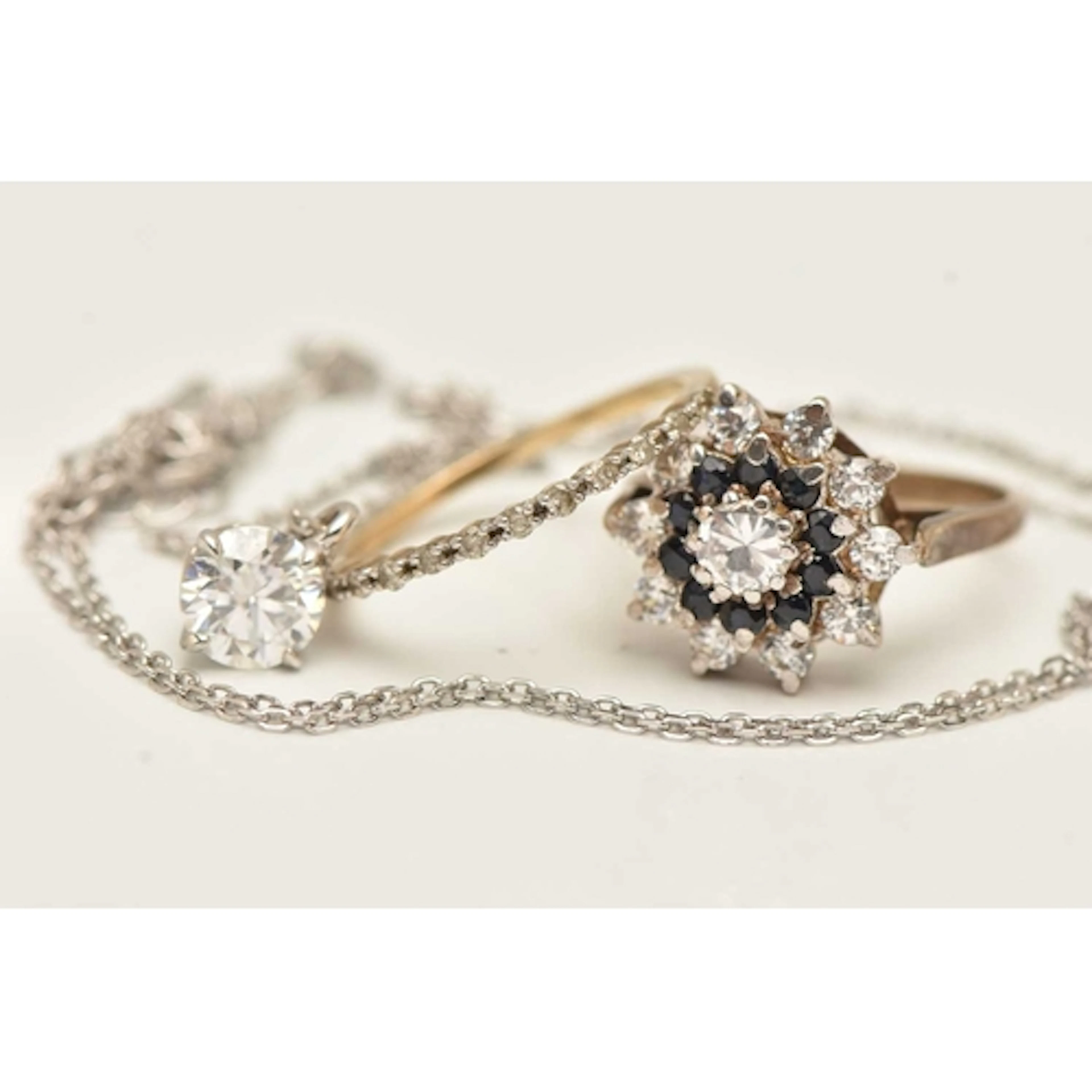 A 9CT GOLD DIAMOND ETERNITY RING, A MOISSANITE PENDANT NECKL...