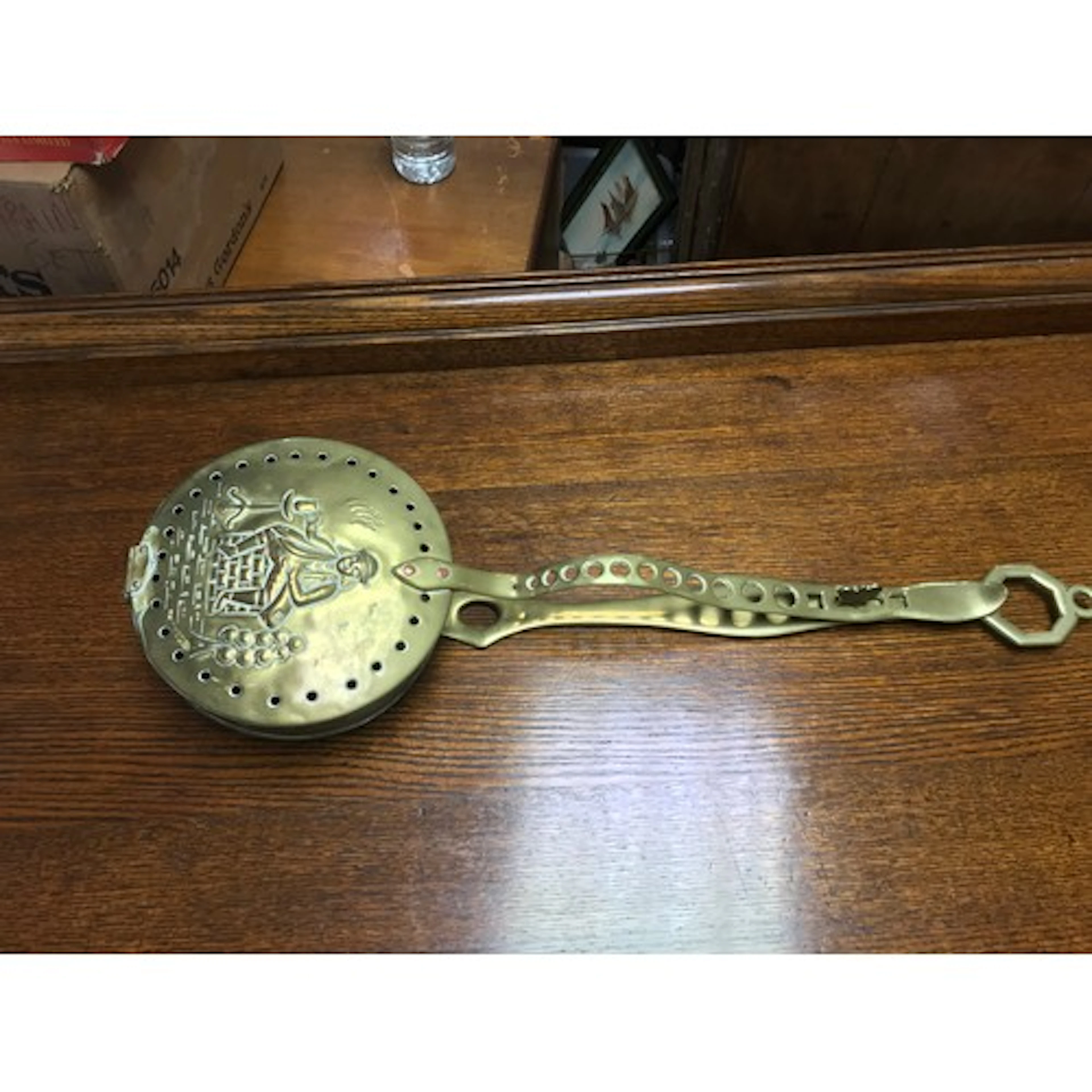 A brass chestnut warming pan. 57cm long