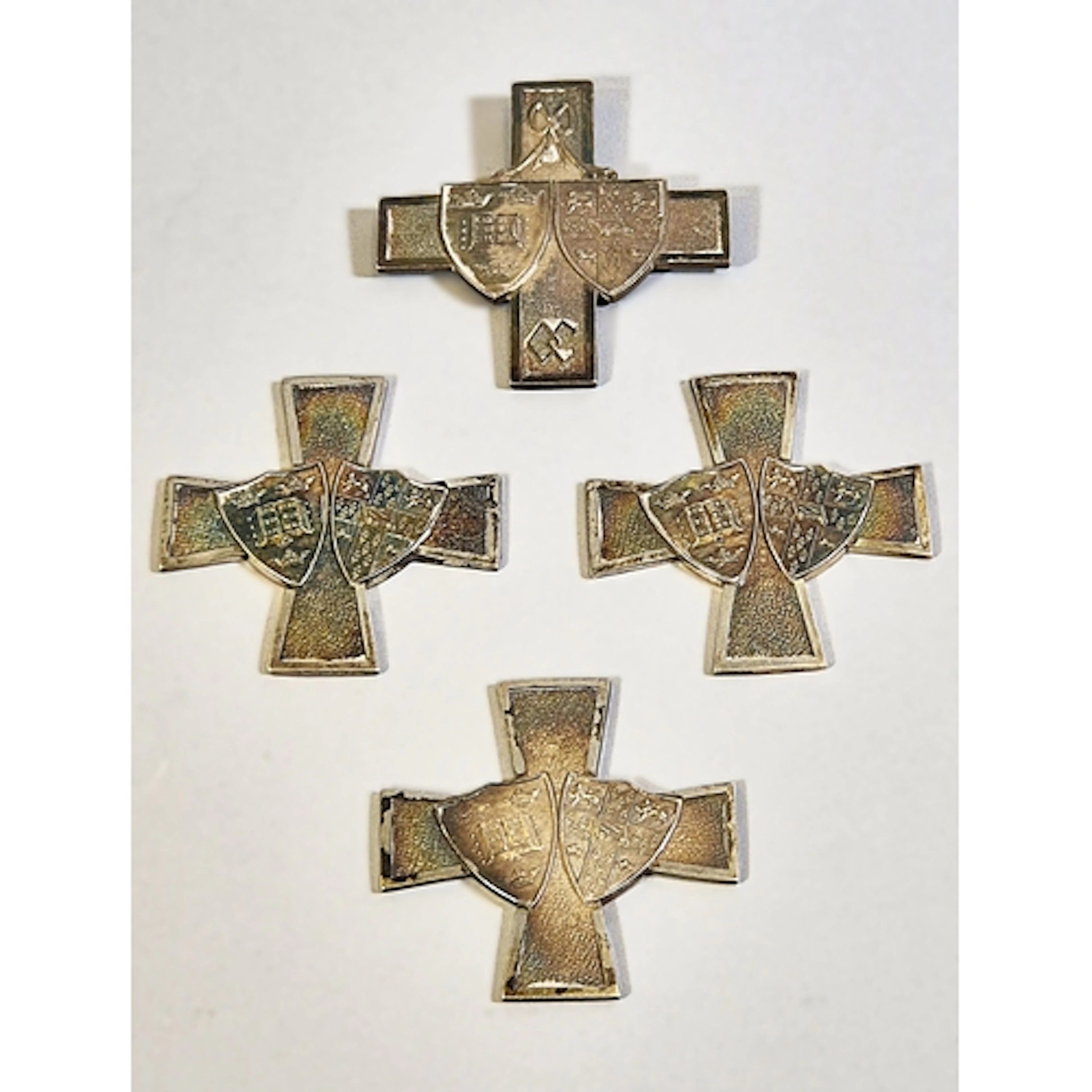 Four near matching silver shooting medals of cruciform shape...