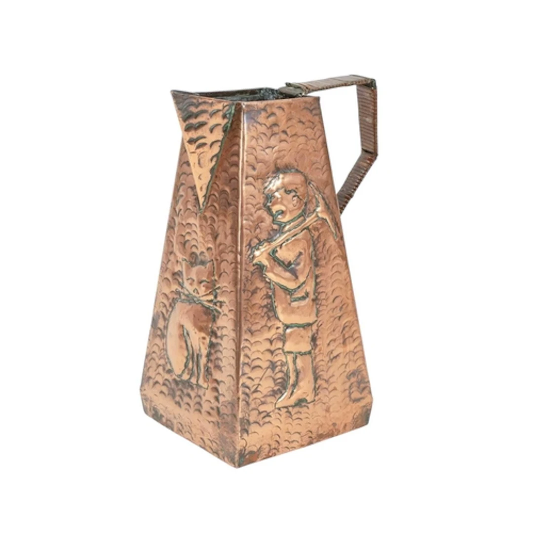 An Arts and Crafts copper water jug. Probably Cornish, of ta...