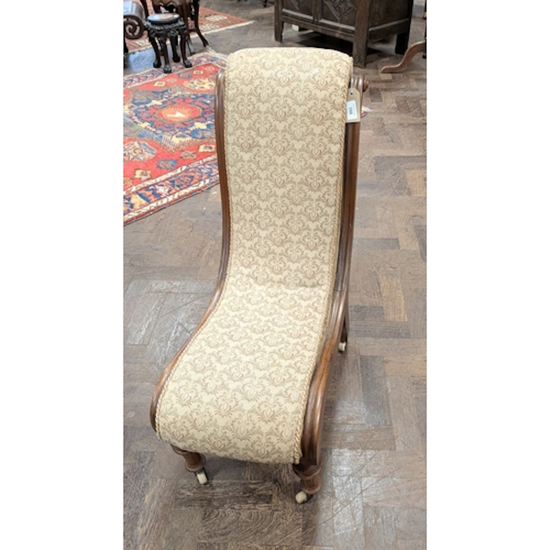 A Victorian carved walnut slipper chair upholstered in a bro...