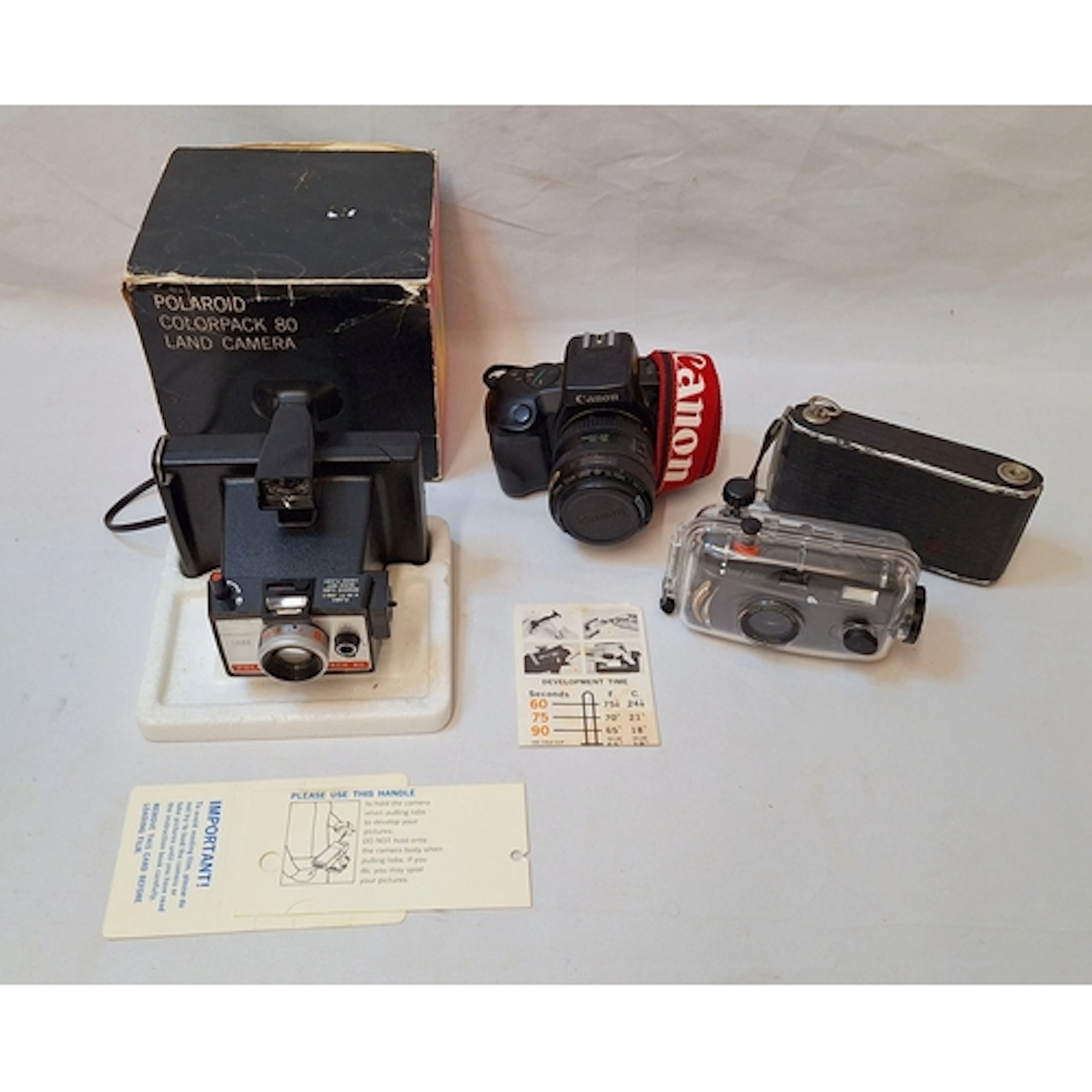 Canon EOS 750 35mm camera, Polaroid Land Camera 80 in box, v...