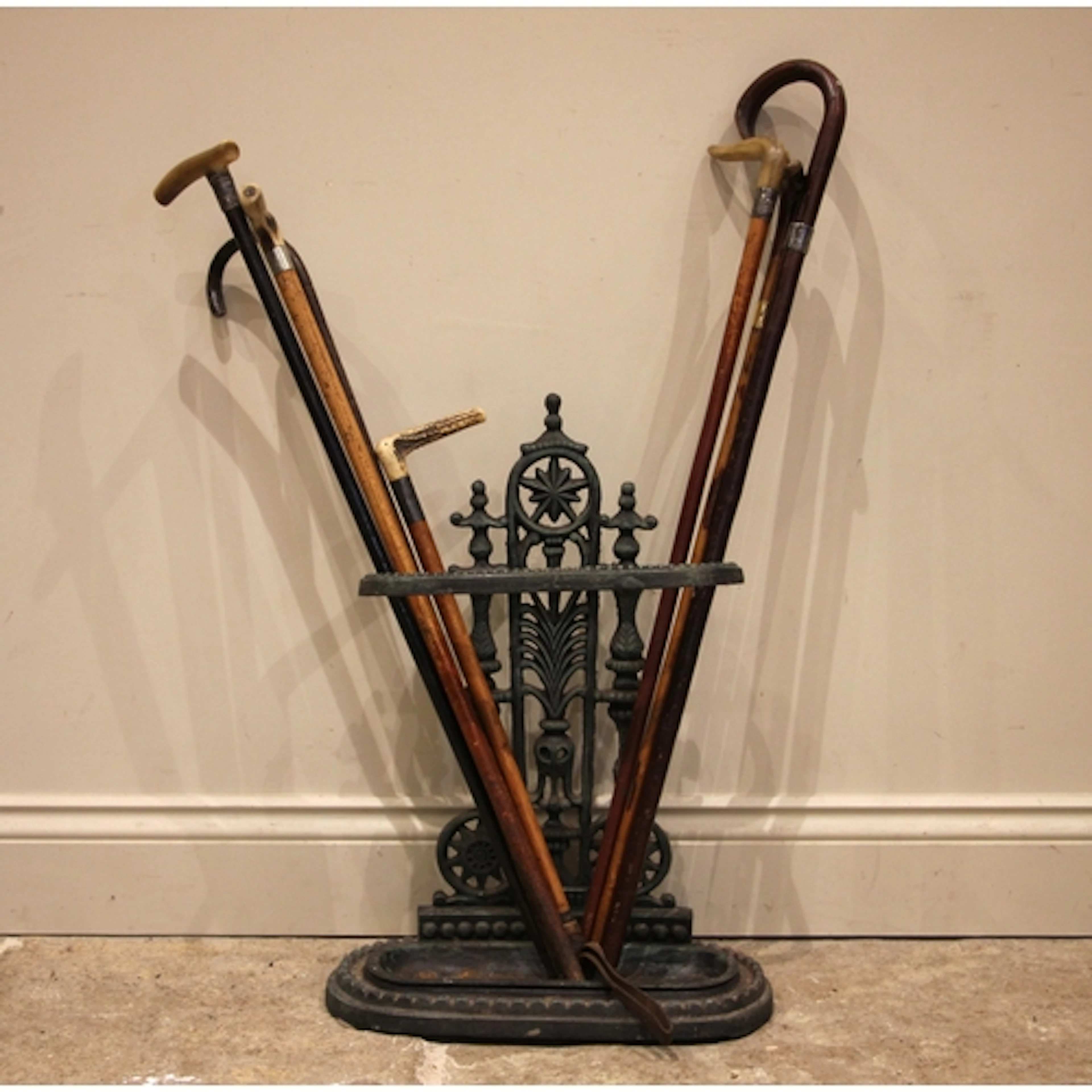 A Victorian cast iron stick stand, of typical form with hoop...