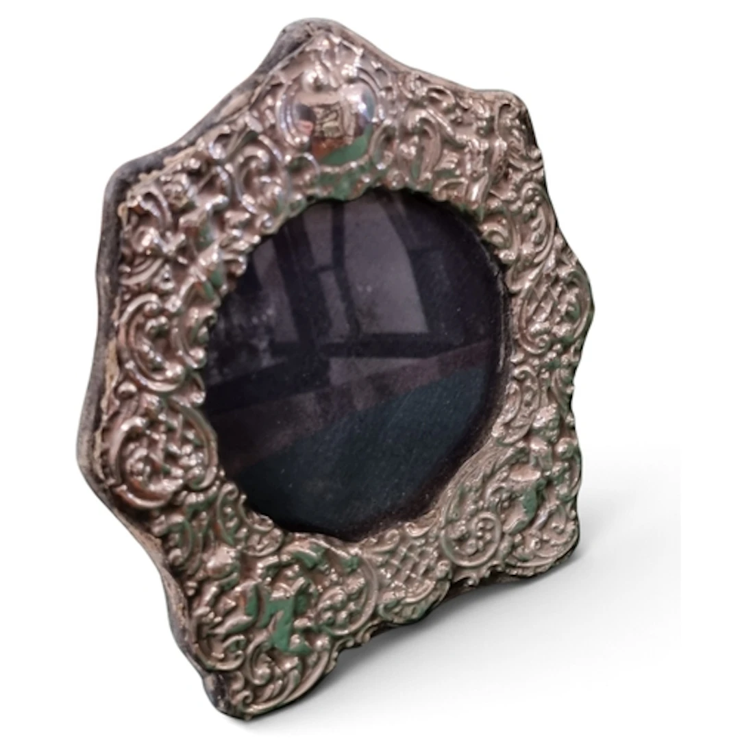 A good London Repousse Silver photograph Frame decorated wit...